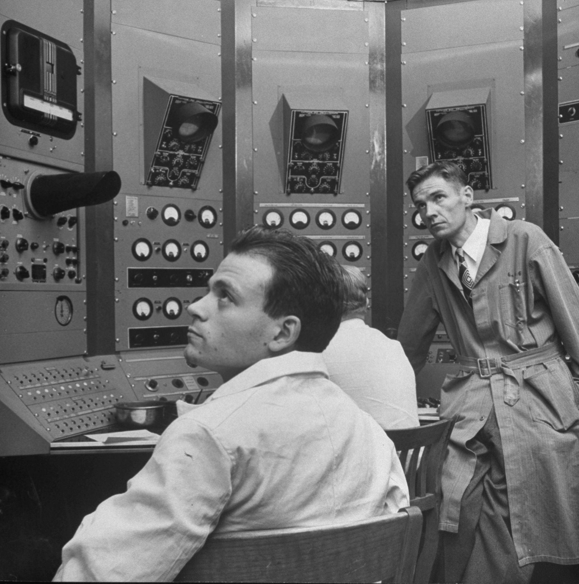 Dr. Eugene Gardner, 35, and Brazilian-born Dr. C.M.G. Lattes, 23, in the control room of UC-Berkeley's cyclotron, 1948.
