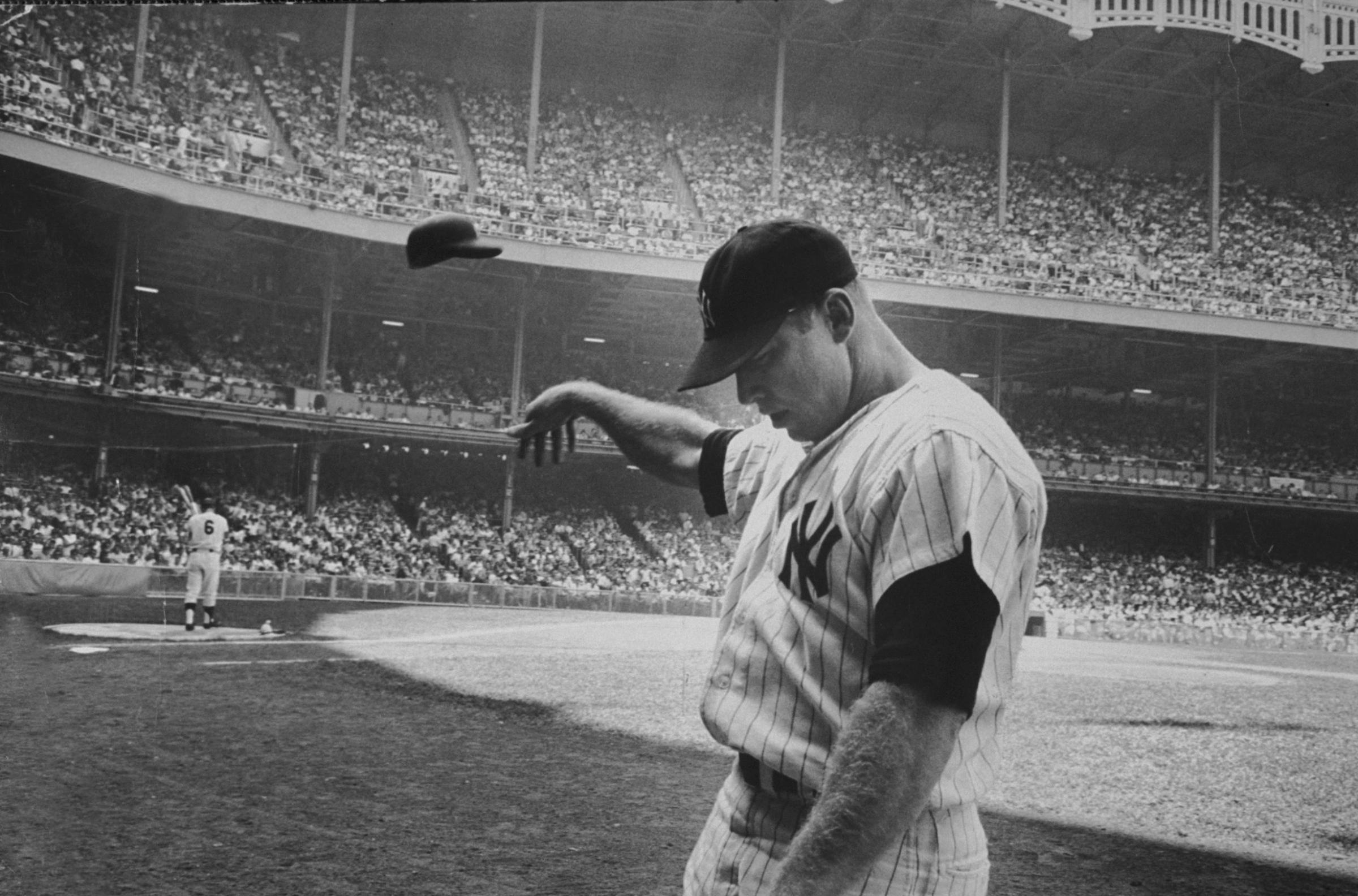 After a weak at-bat, Mickey Mantle flings his helmet away in disgust, June 25, 1965.
