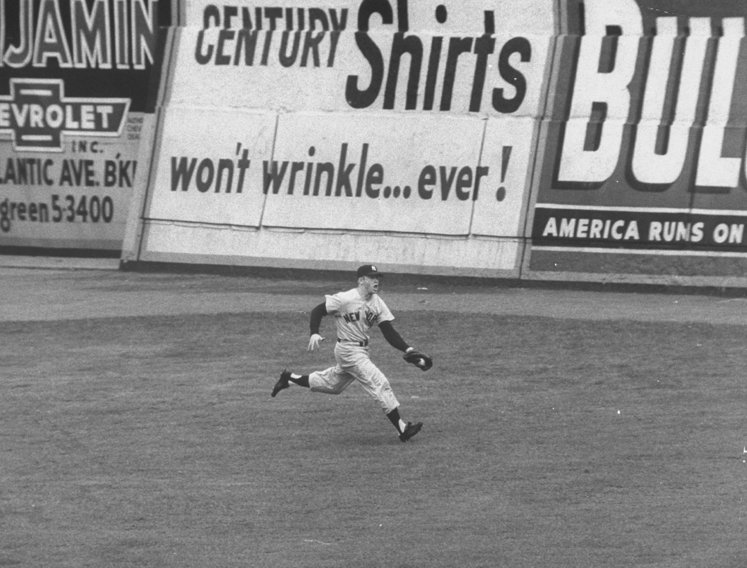 Mickey Mantle makes a running catch on a fly ball to left field during the 3rd game of the World Series at Ebbets Field in Brooklyn, NY on September 30, 1955.