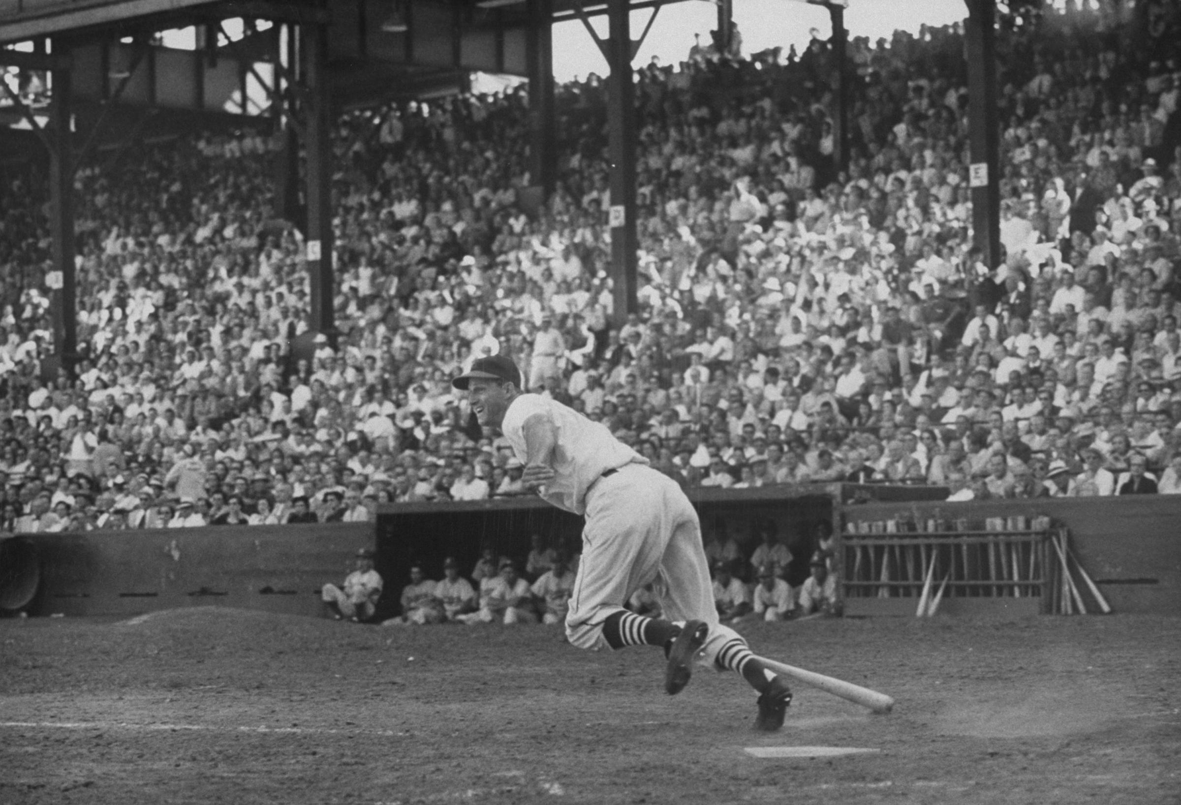After slapping a hit to center, Stan Musial dashes toward first, 1952.