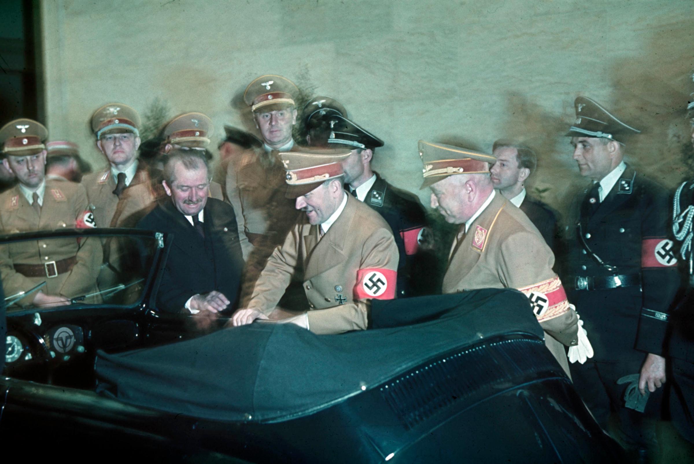 Ferdinand Porsche (left, in dark suit) presents a newly designed convertible VW to Adolf Hitler in celebration of the Fuhrer's 50th Birthday, Berlin, Germany, 1939.