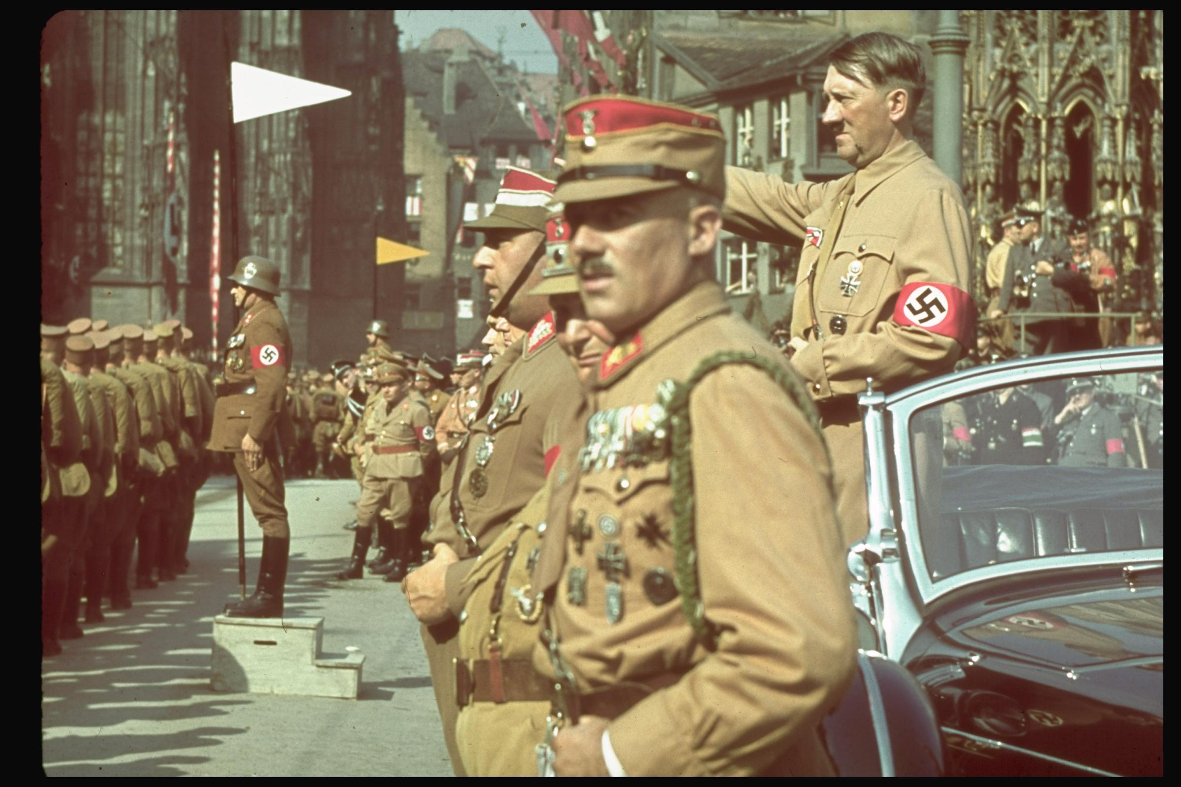Hitler salutes German troops in 1938.