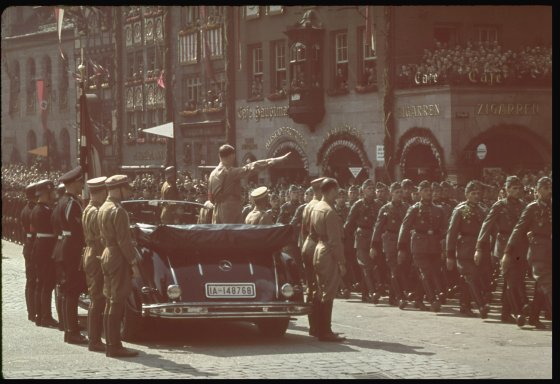 Nazi troops parade before Hitler in 1938 Nuremberg.
