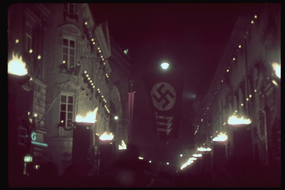 Nighttime Munich is lit with torches and festooned with swastikas in celebration of the 15th anniversary of the 1923 Beer Hall Putsch, 1938.