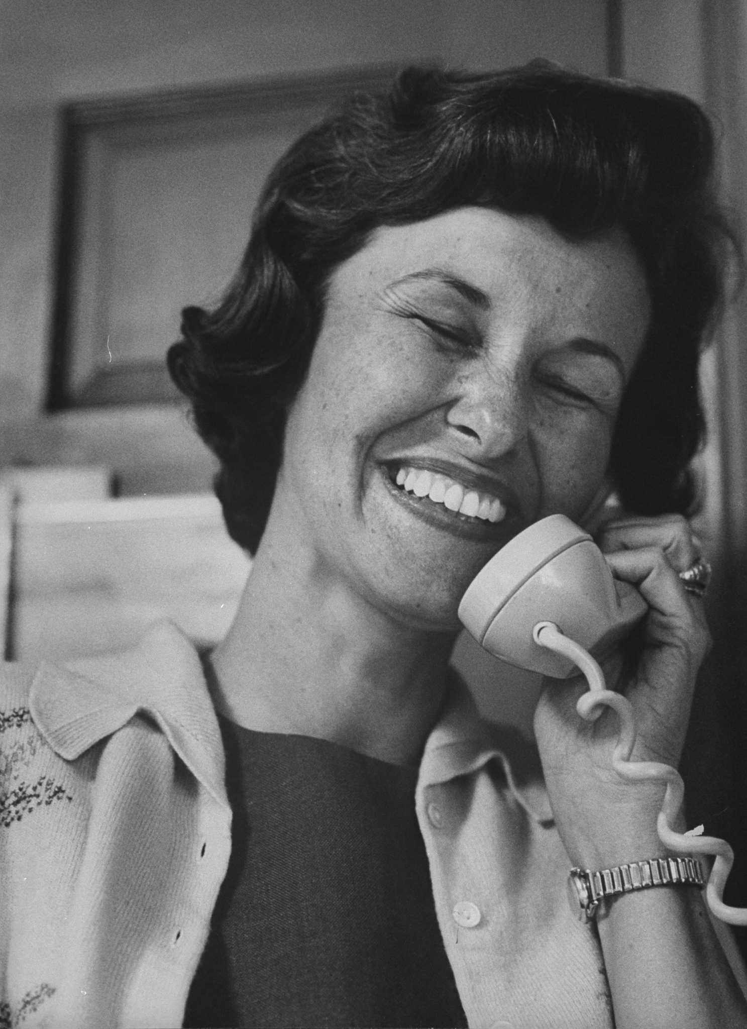 Relief and joy reflected in equal measure on her face, Louise Shepard takes one of the countless calls she received in the moments after her husband Alan's safe splashdown, May 1961.