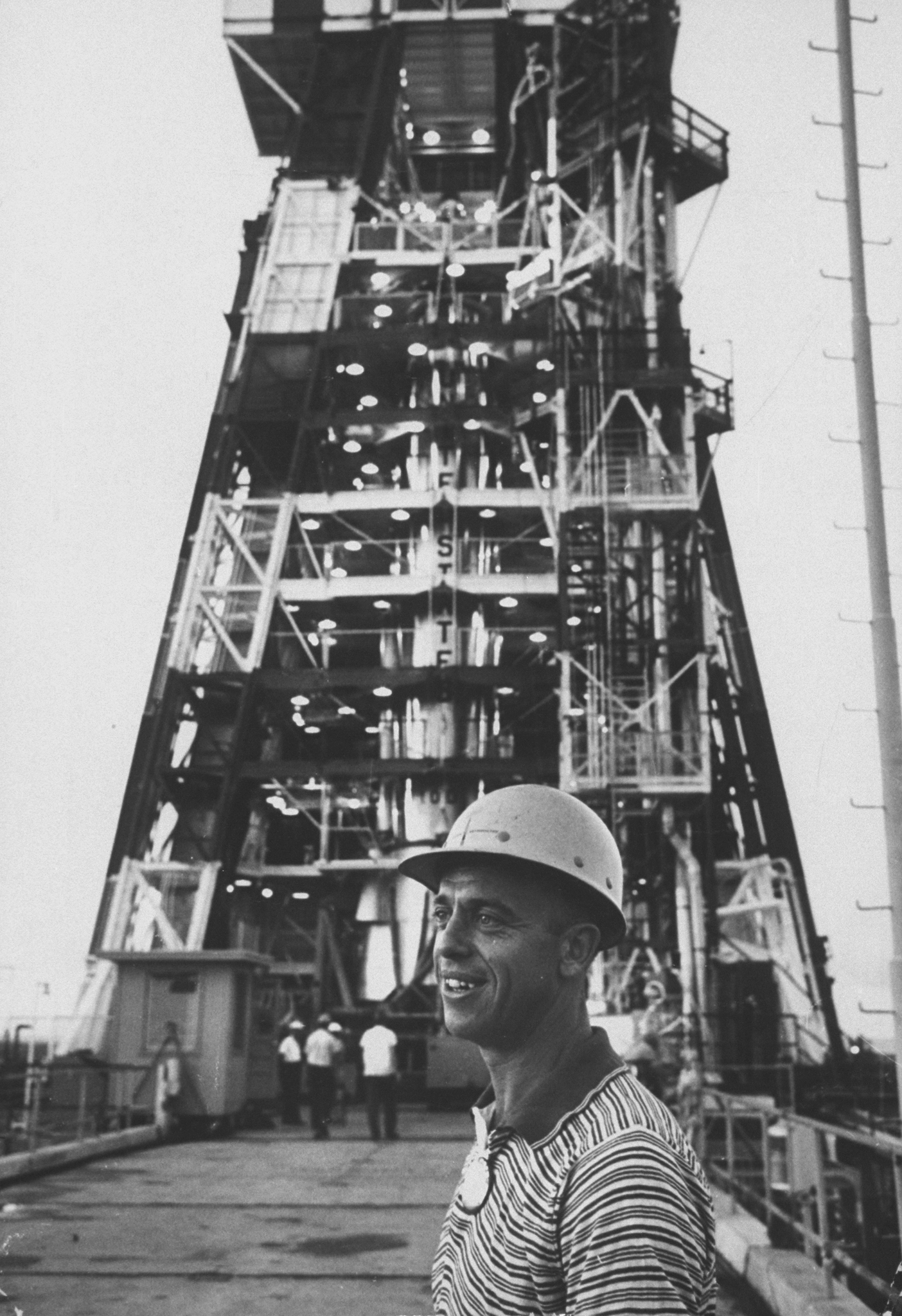 Alan Shepard standing next to a missile launch platform, 1959.