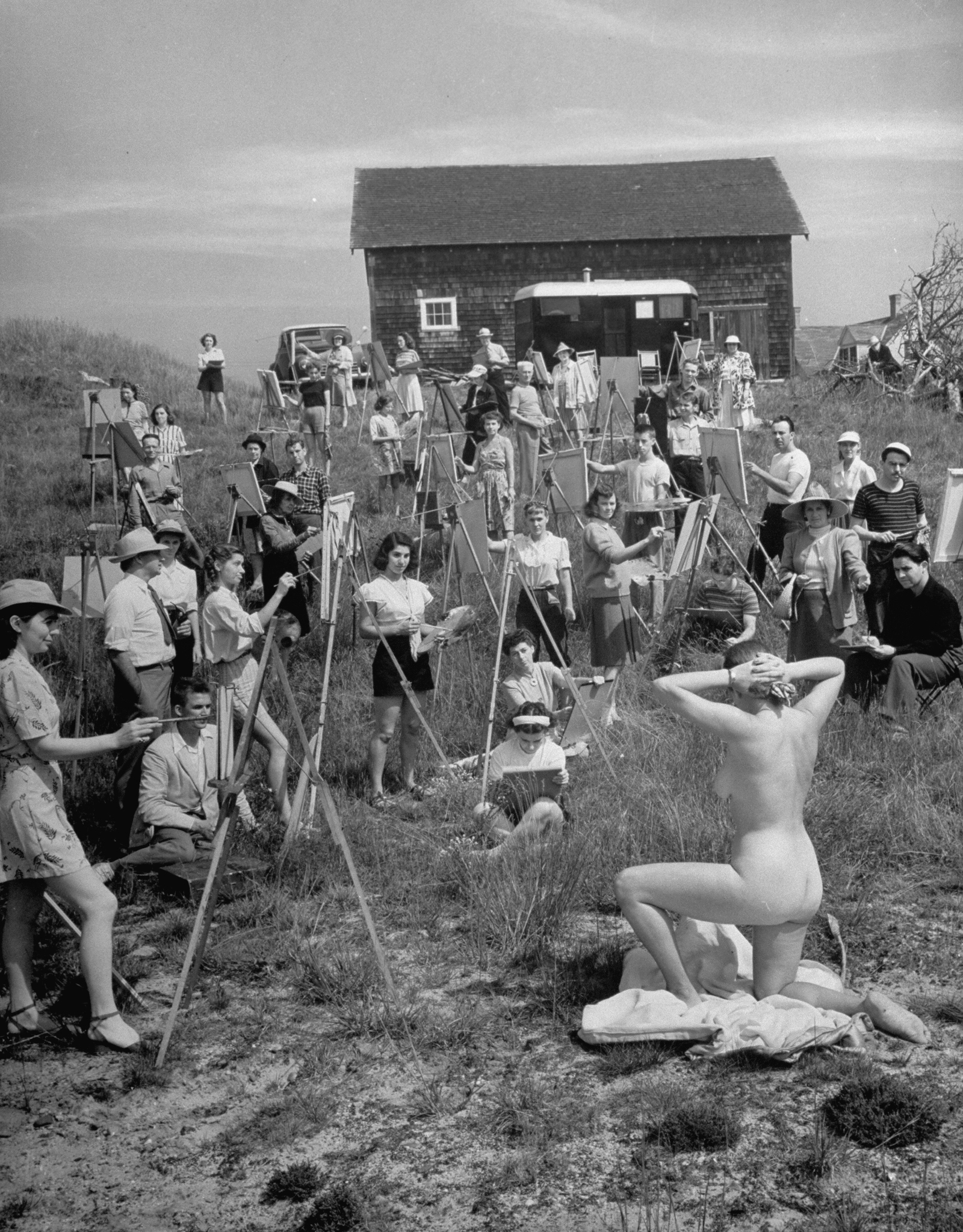 A large group of Farnsworth Art School students paint a nude model in 1946.