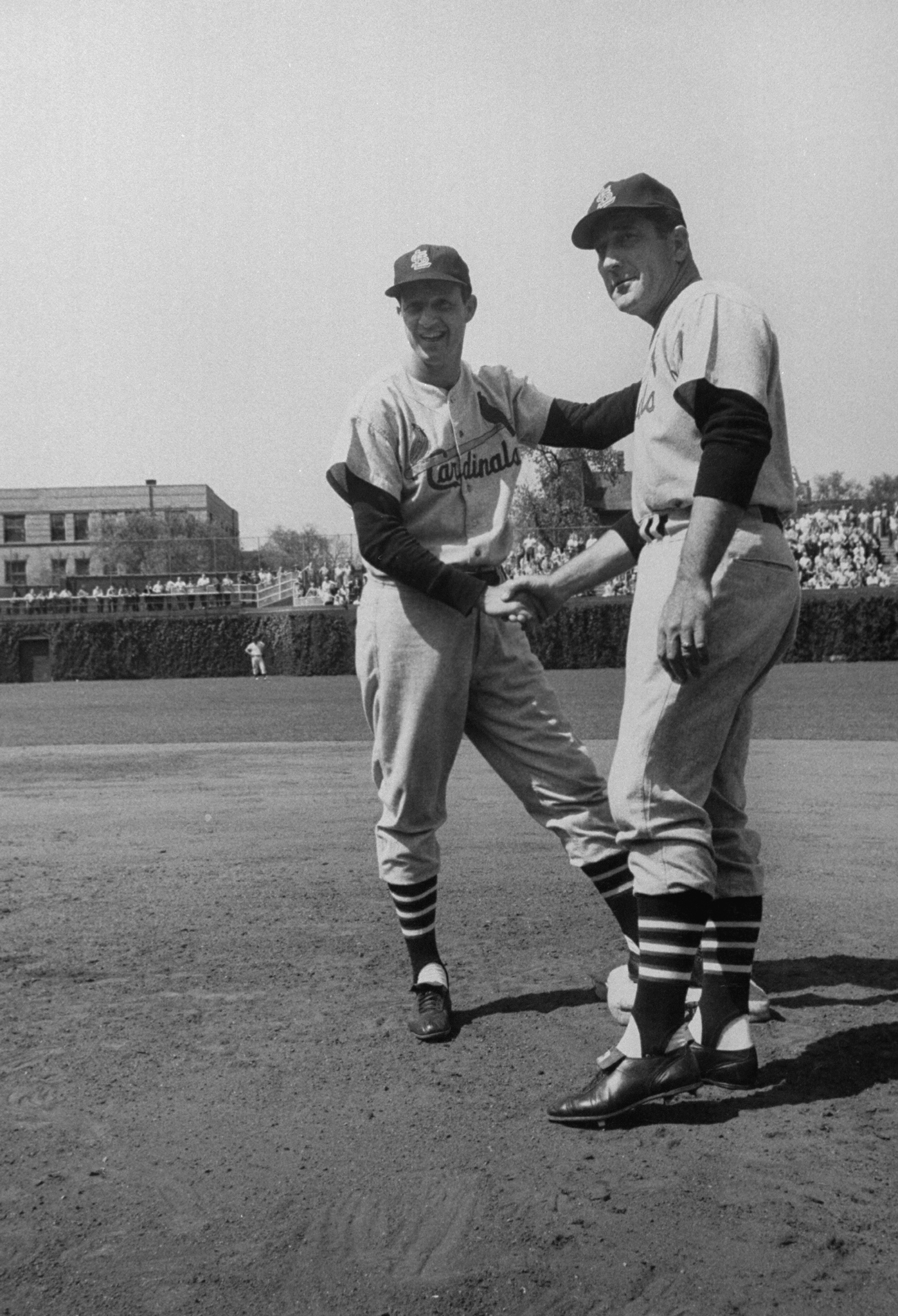 Manager Fred Hutchinson (right) congratulates Stan Musial after his 3,000th hit, a pinch-hit double off the Cubs' Moe Drabowsky in 1958.