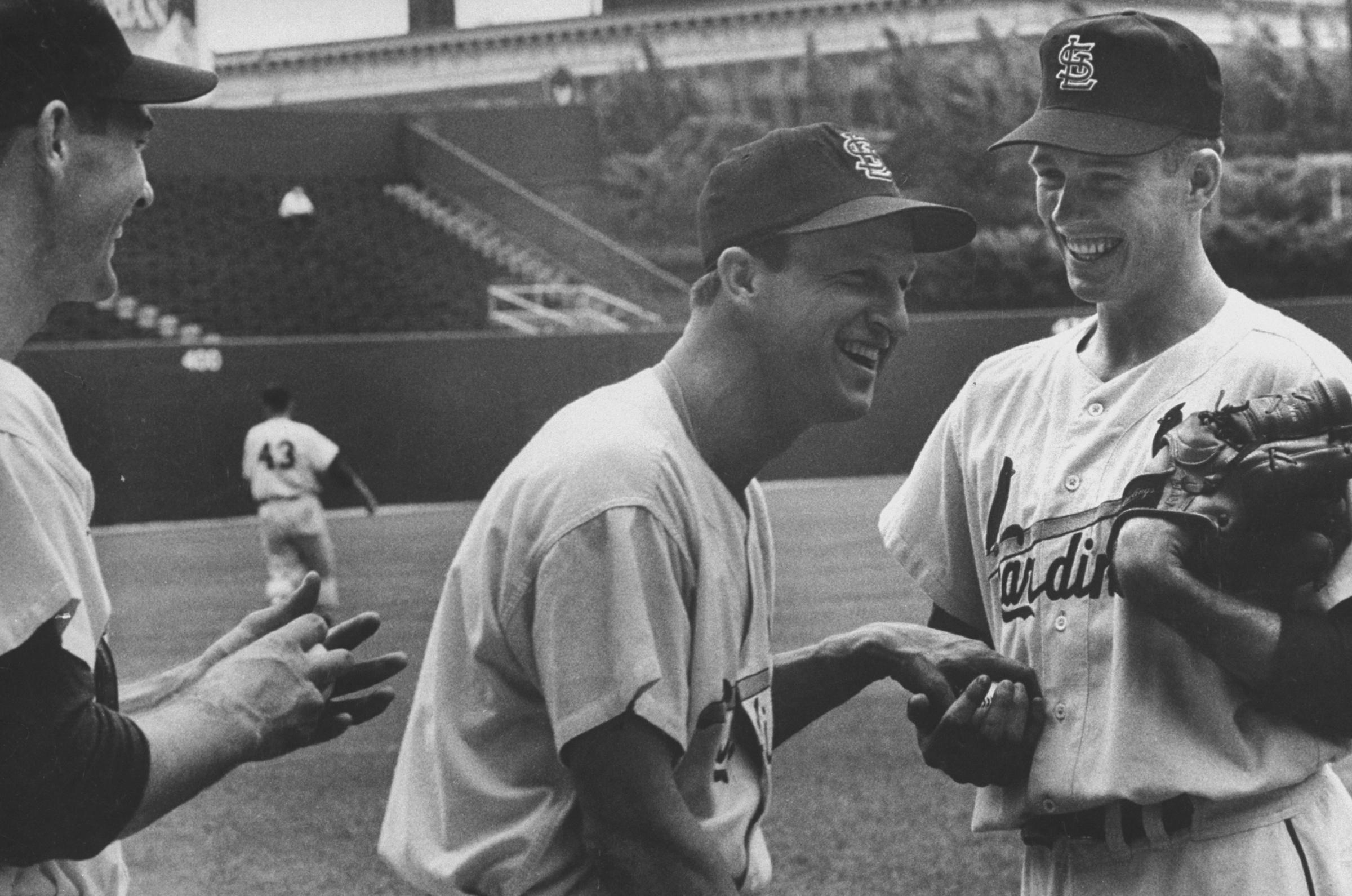 Stan Musial (center) shares a joke with teammates and brothers Lindy and Von McDaniel, 1955.