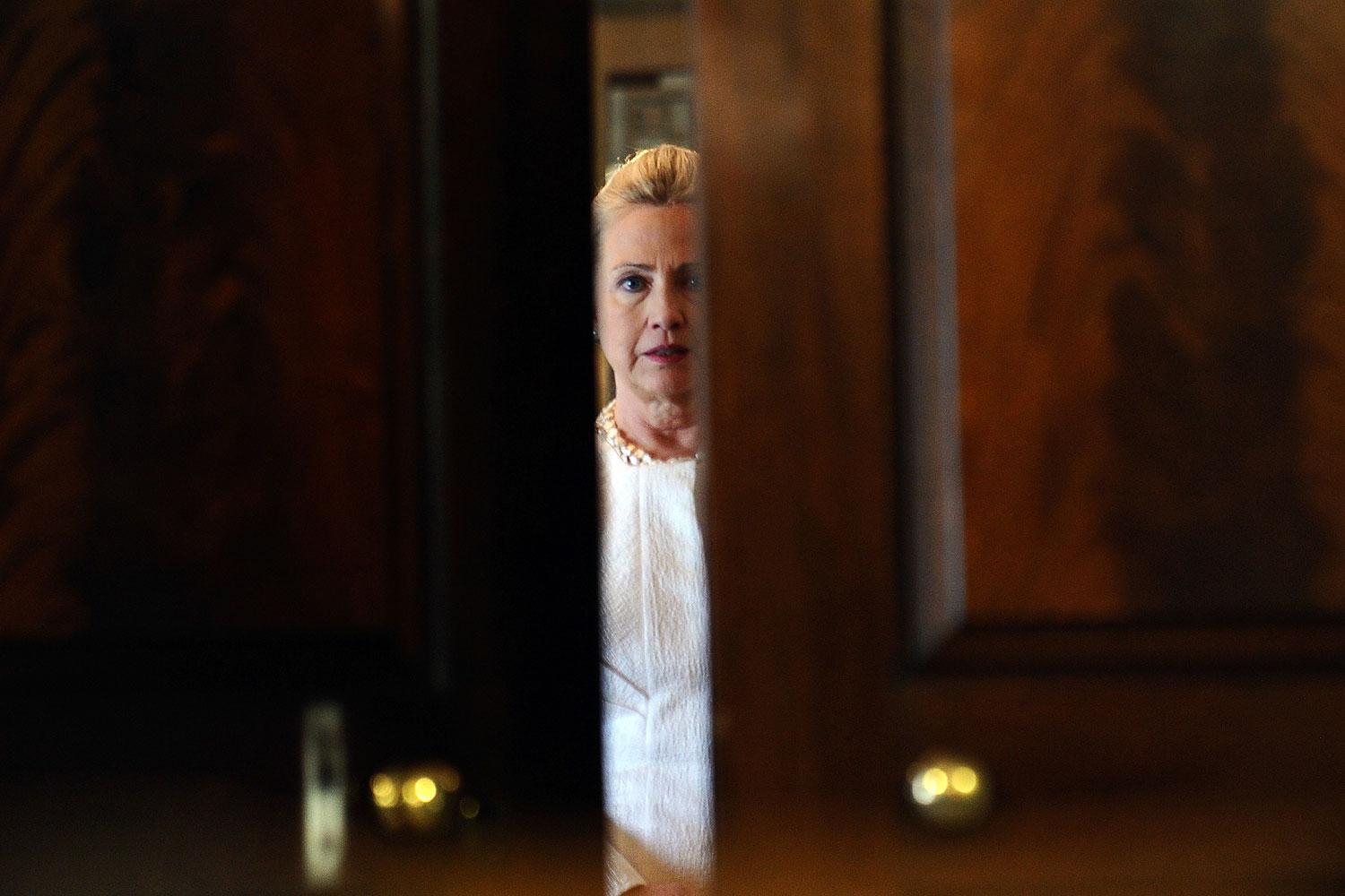 January 12, 2012. US Secretary of State Hillary Clinton is seen through a door before giving press conference with Algerian Foreign Minister at the State Department in Washington, DC.