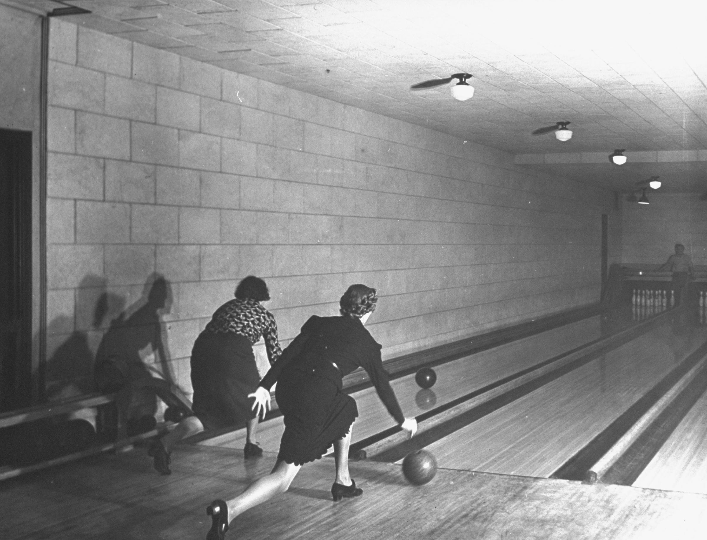 Women bowl in two of the four bowling alleys located under the chapel of New York's Riverside Church.