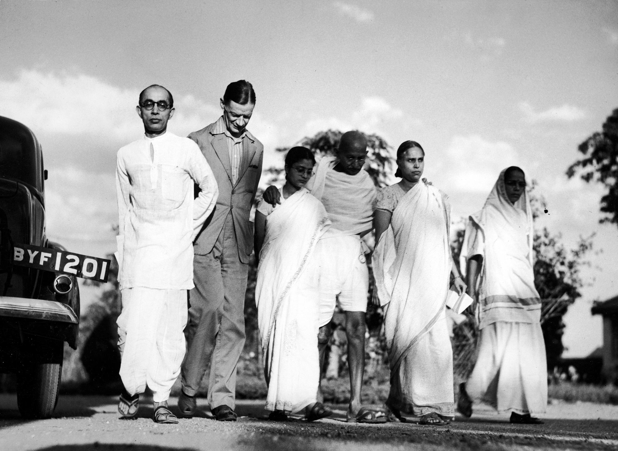 Gandhi, center, is shown walking with family members and an official (in suit) from the Friend's Ambulance Unit -- an international organization focused on famine relief -- in 1946.