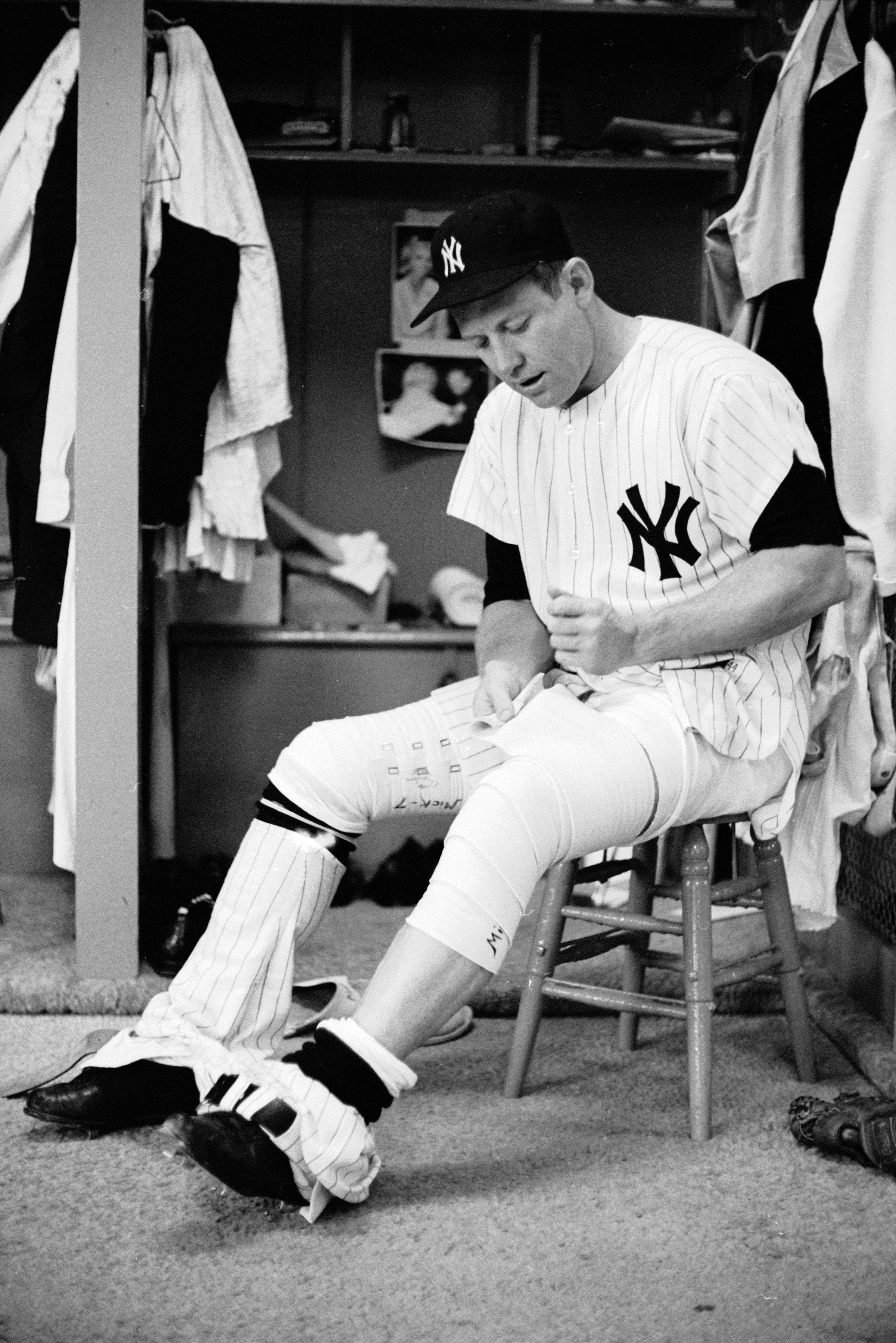 Mickey Mantle bandages his leg in the locker room before a game, June 1965.