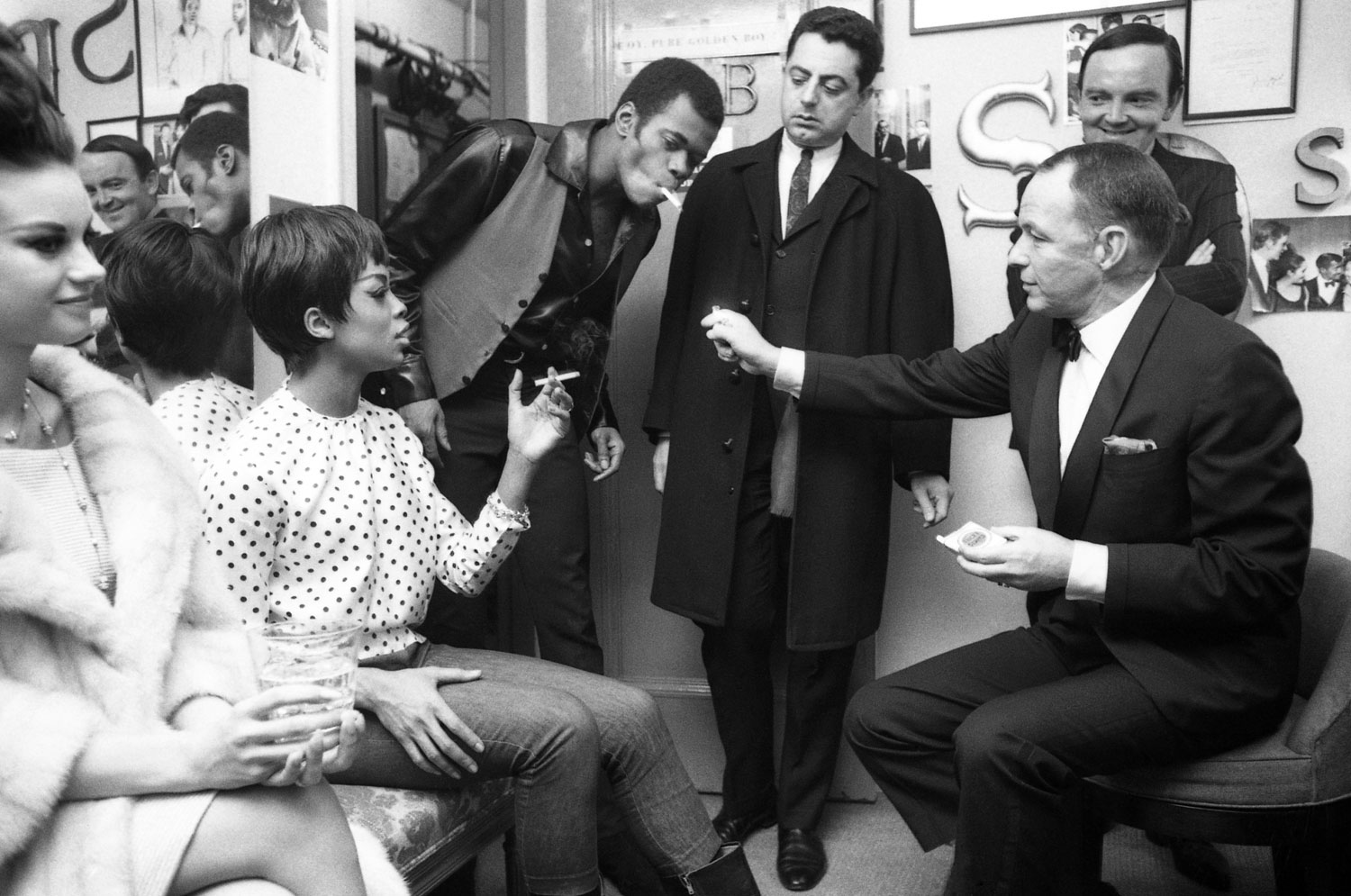 Frank Sinatra offers a light in Sammy Davis Jr.'s Golden Boy dressing room in 1964.