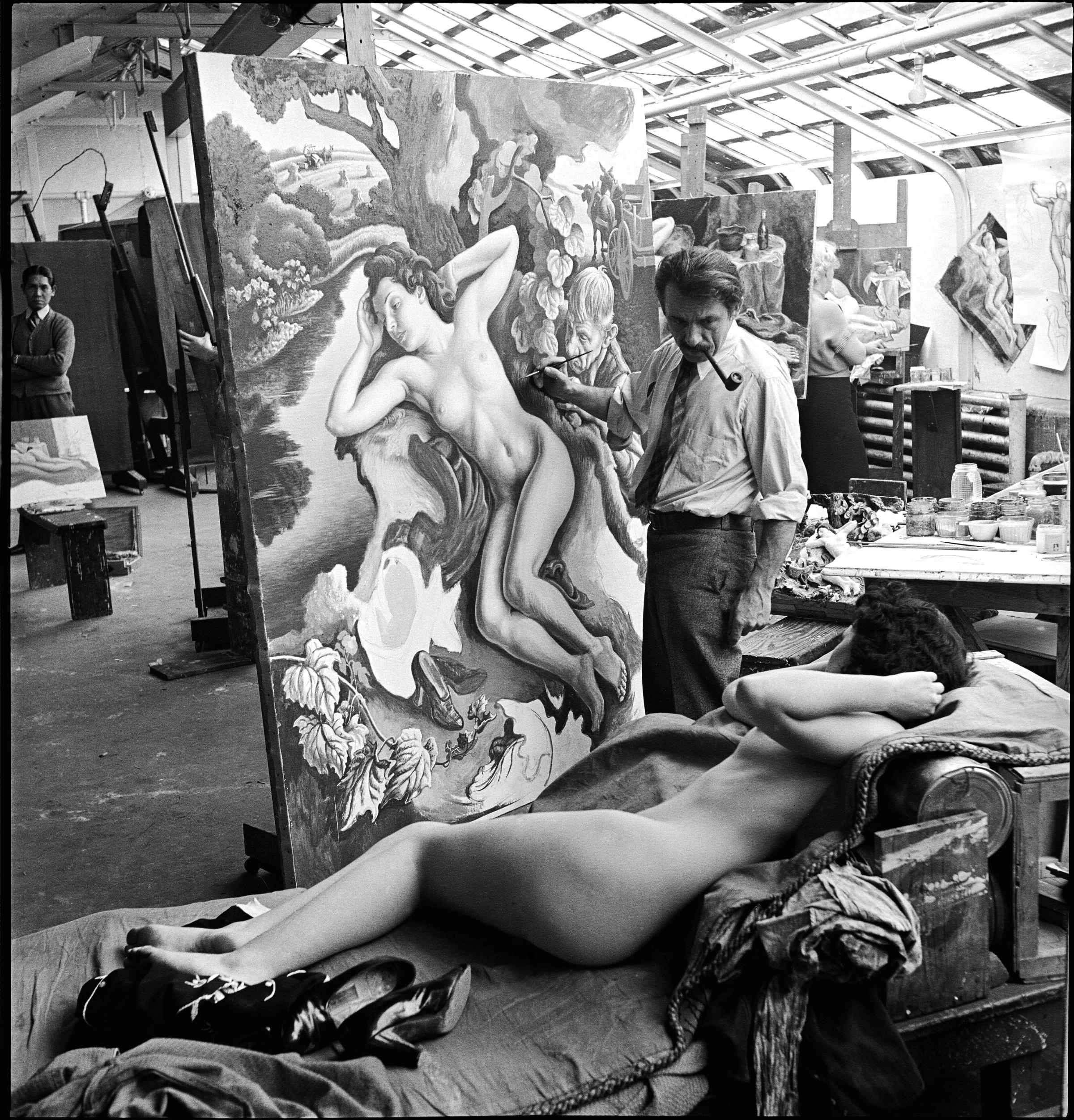 The American painter Thomas Hart Benton (1889 - 1975) works on his painting "Persephone"