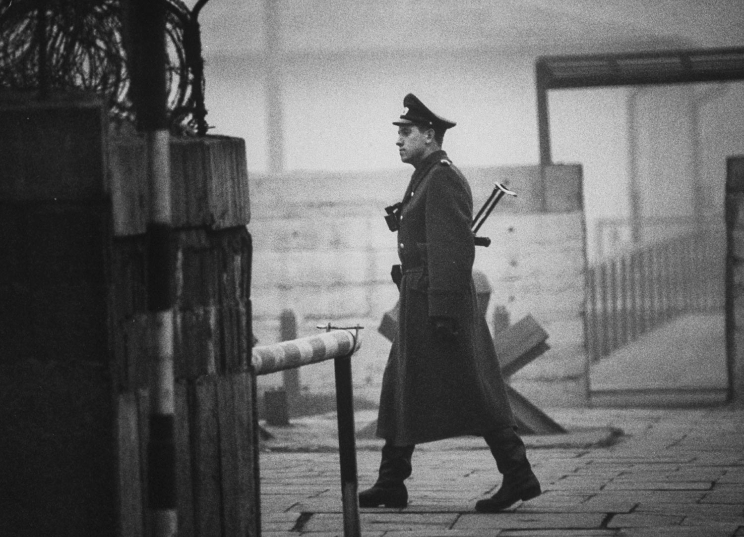 An East German policeman walks near Checkpoint Charlie in Berlin