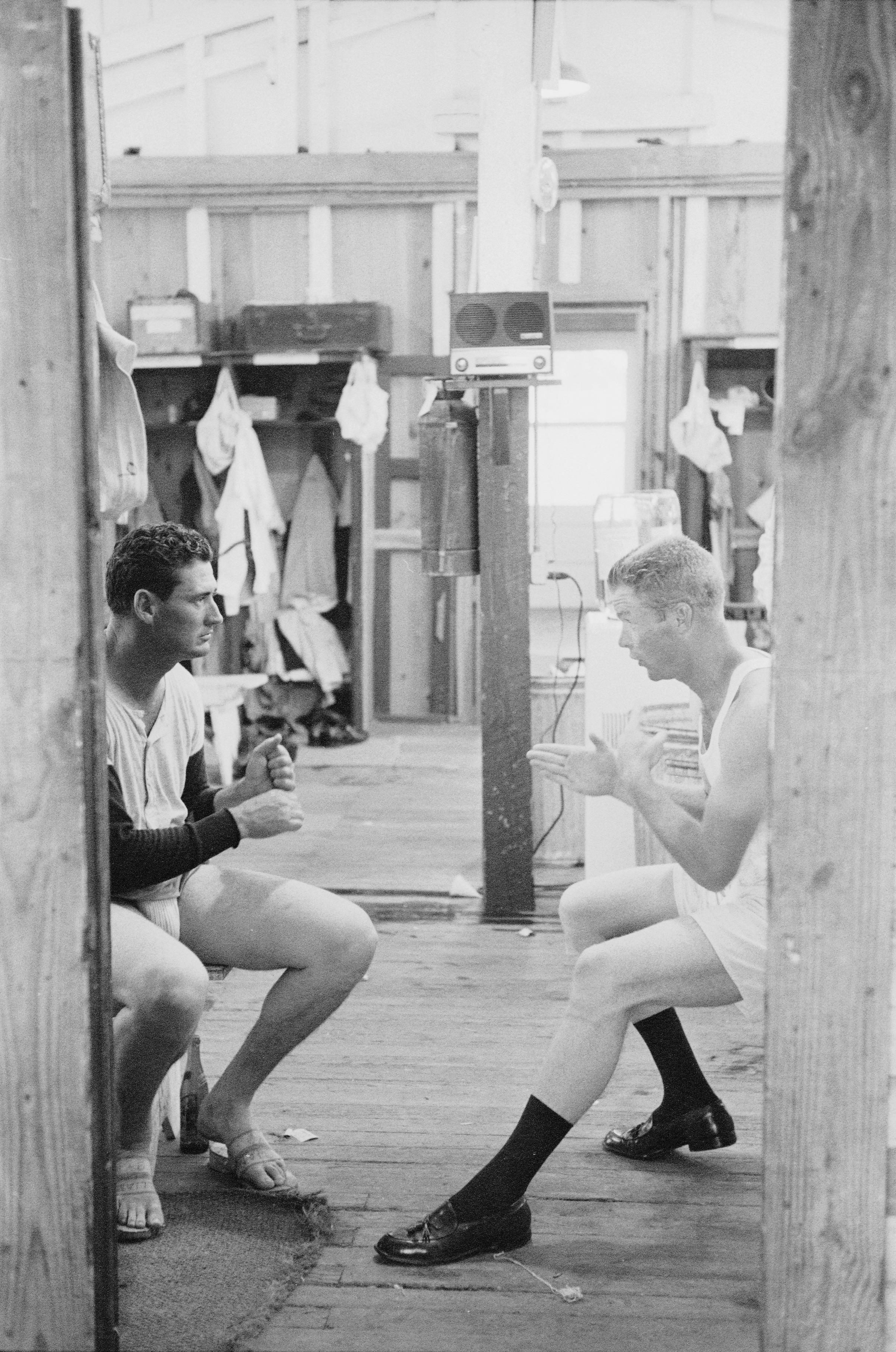 Ted Williams of the Boston Red Sox, left, talks with teammate Gordon Windhorn about batting in the locker room during spring training, Sarasota, Florida, 1956.