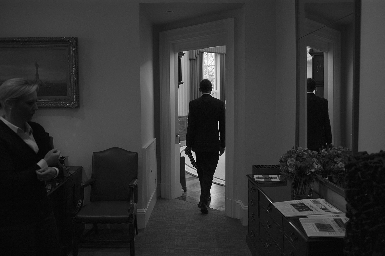 January 17, 2012. The President enters the Oval Office while his secretary stands at the far left.