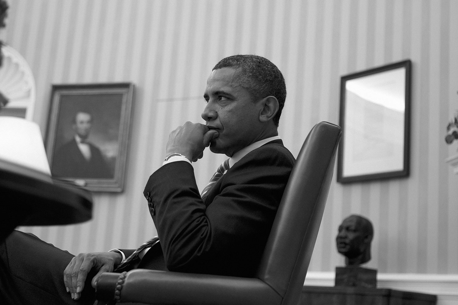 January 17, 2012. Obama sits in the Oval Office during a meeting with senior advisers.