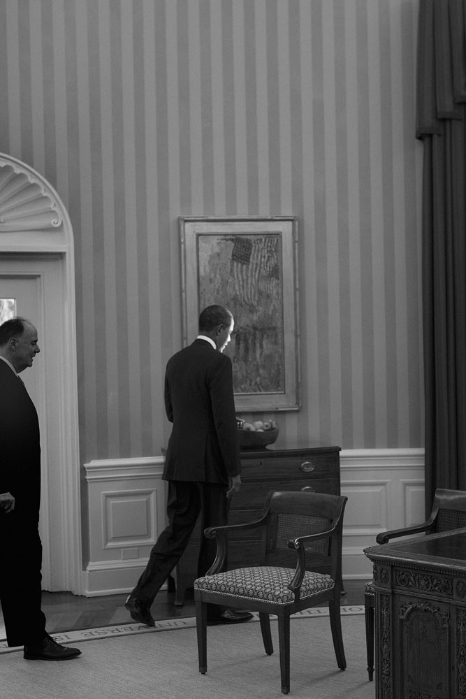 January 17, 2012. President Barack Obama walks back to his desk in the Oval Office.