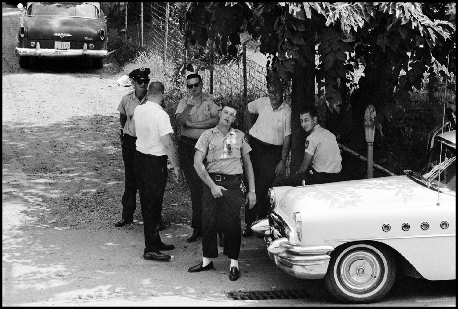Police pose for a photograph as ministers from the National Council of Churches march to a local church, Clarksdale, Miss, 1963
