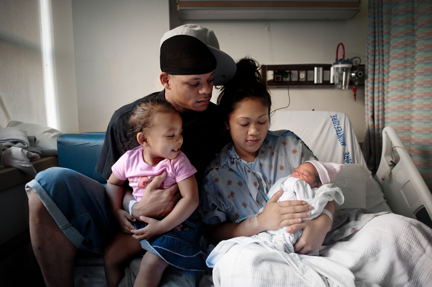 Bronx, New York City, September 2011.Joseph, 30, Sothea, 28, and Sovahnny, 2, at Montefiore hospital in the Bronx, NY, hours after the delivery of the newest addition to their family.