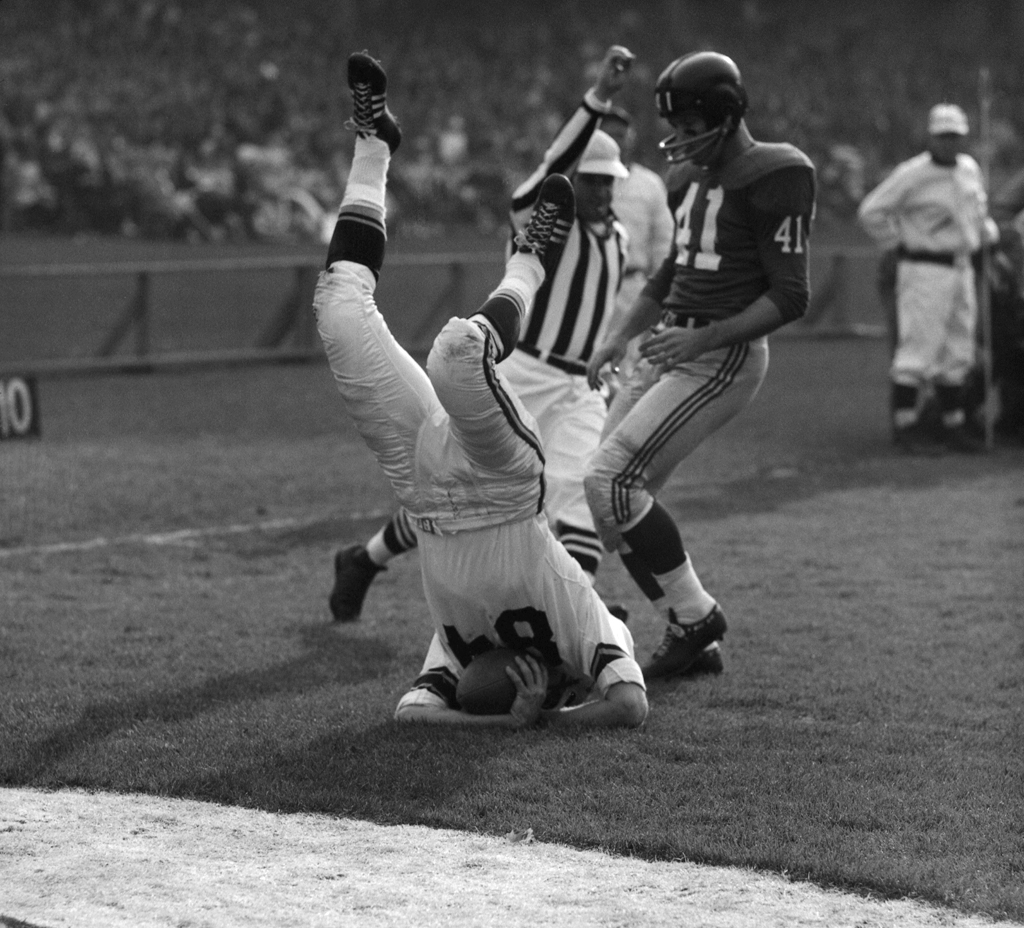 Steelers receiver Buddy Dial (upended) lands on the 1-yard line as the Giants' Lindon Crow arrives a moment too late to make the play.