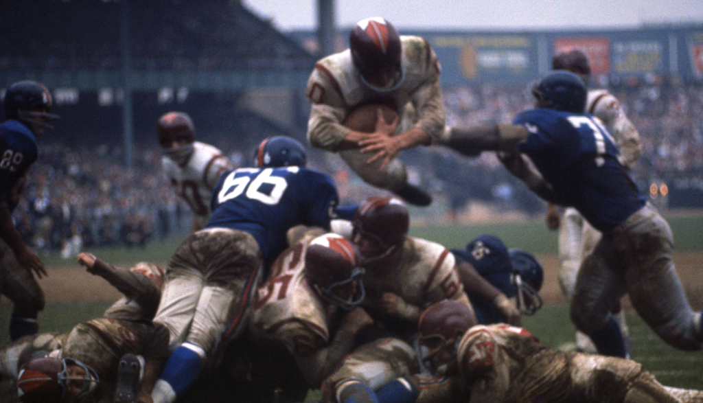 Redskins fullback John Olszewski (wearing a #0 jersey) leaps for a touchdown against the Giants.