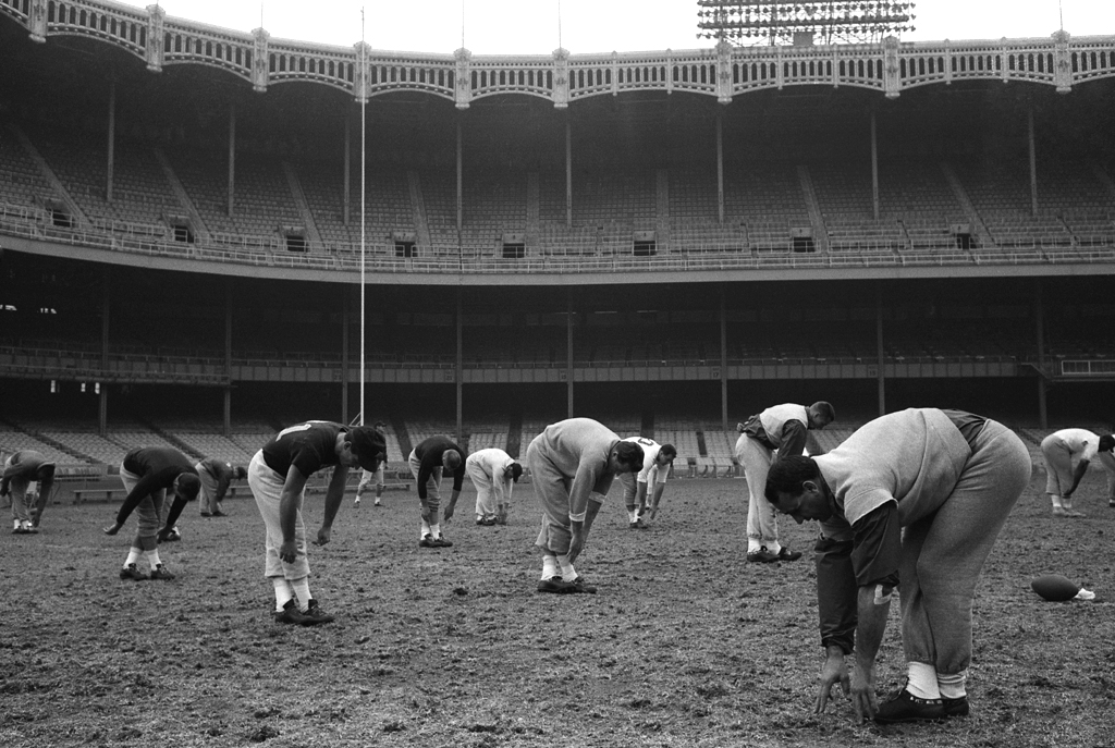 Future Hall of Famer Andy Robustelli leads the Giants in a workout session at Yankee Stadium.