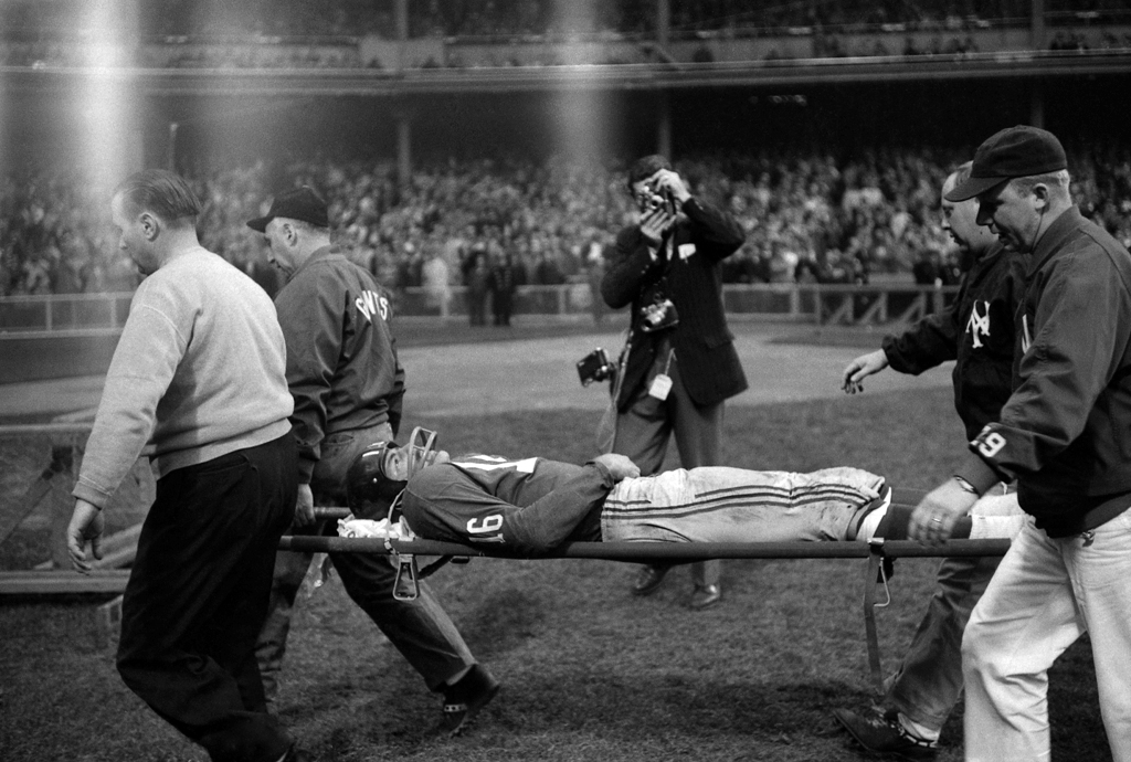 Frank Gifford is carried off the field on a stretcher after a near-career-ending hit by the Eagles' Chuck Bednarik.