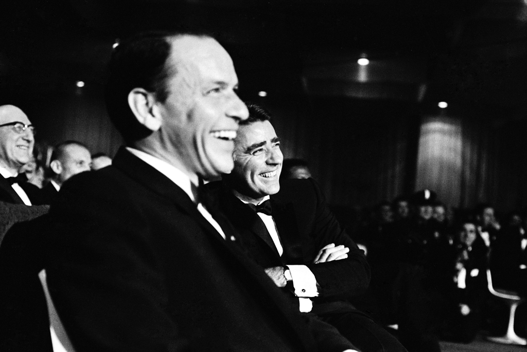 Frank Sinatra and Peter Lawford enjoy the entertainment of the Inaugural Gala.
