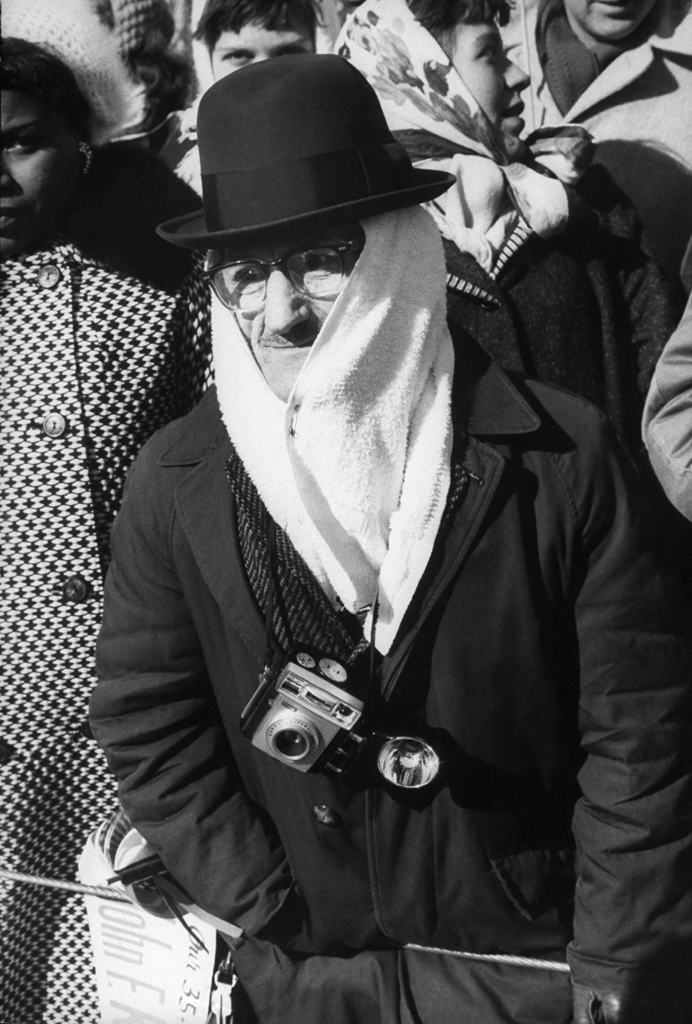 A spectator is seen bundled due to the harsh weather conditions during John Kennedy's inauguration.