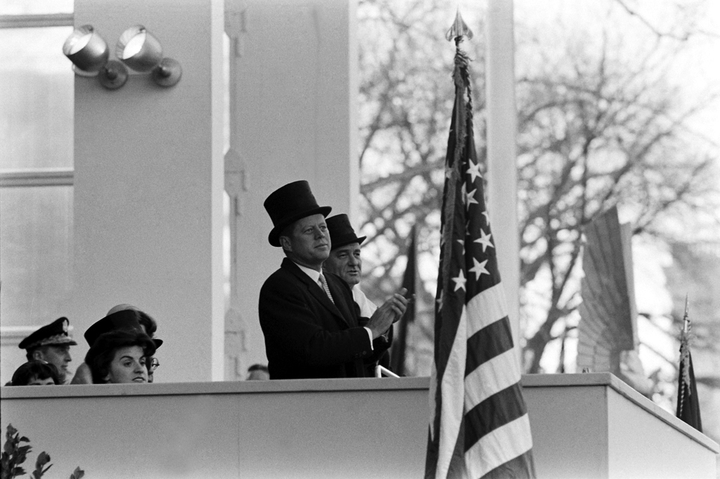 John Kennedy is seen wearing a top hat and overcoat during his inauguartion.