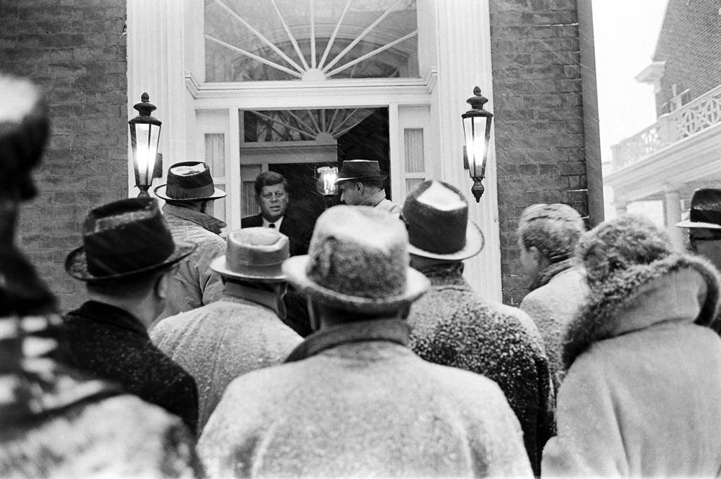 John Kennedy speaks to the press during a snowstorm the day before his inauguration.