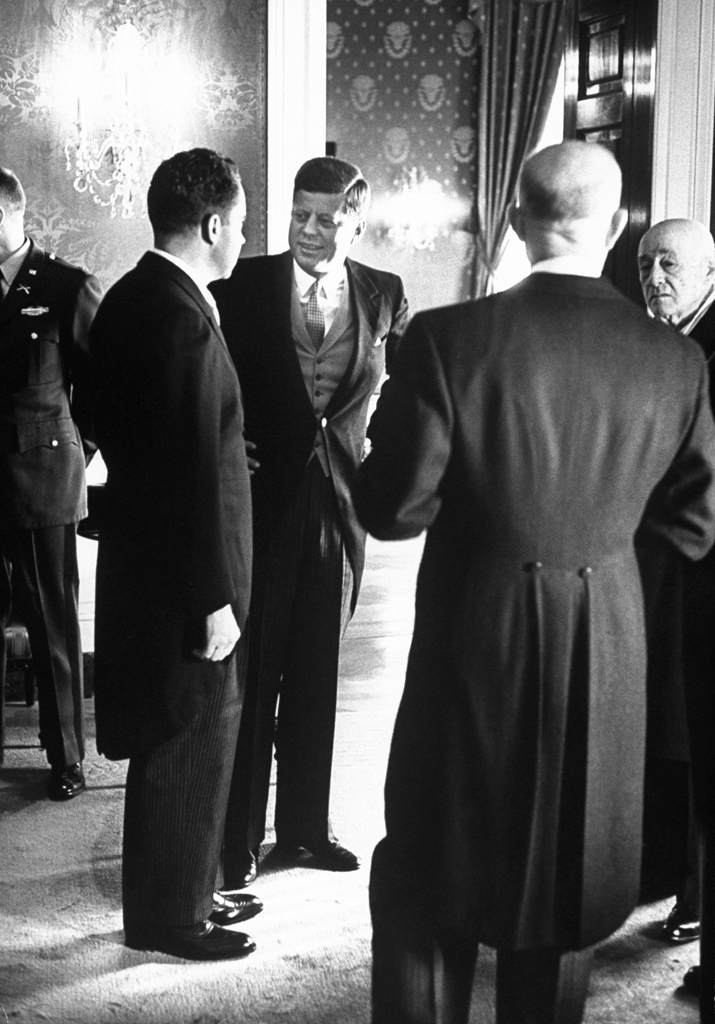 Richard Nixon and John Kennedy speak during a receiption after JFK's inauguration