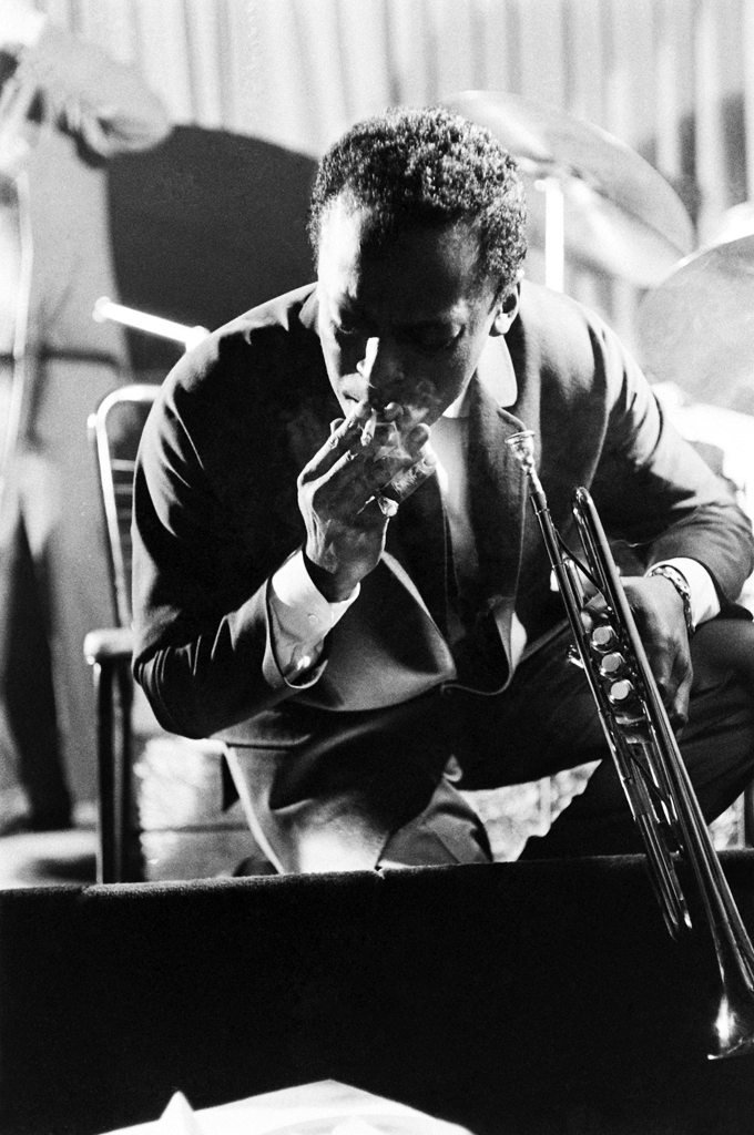 Miles Davis takes a break from performing at a club in New York, 1958.