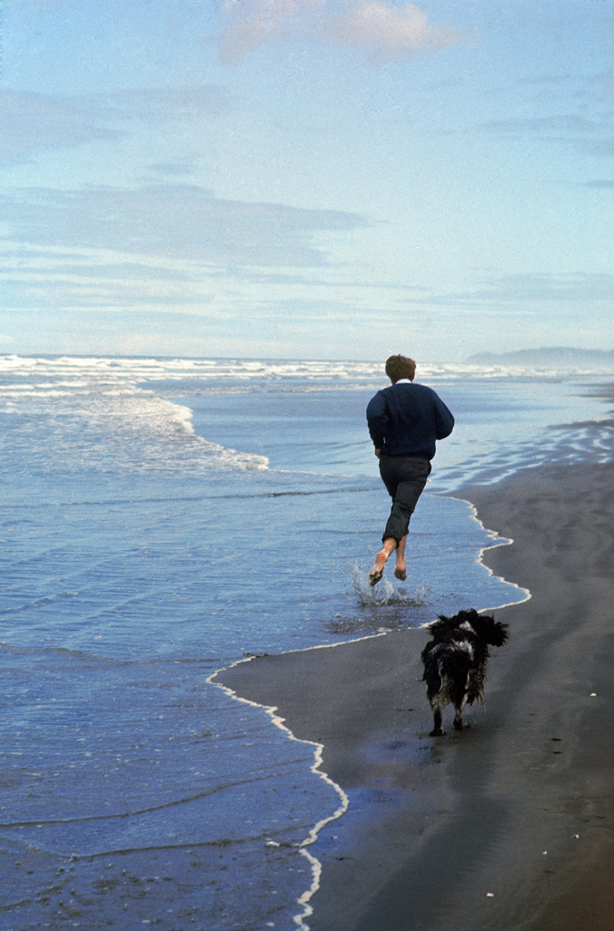 Robert Kennedy runs with his dog, Freckles, along the Oregon coast, 1968.
