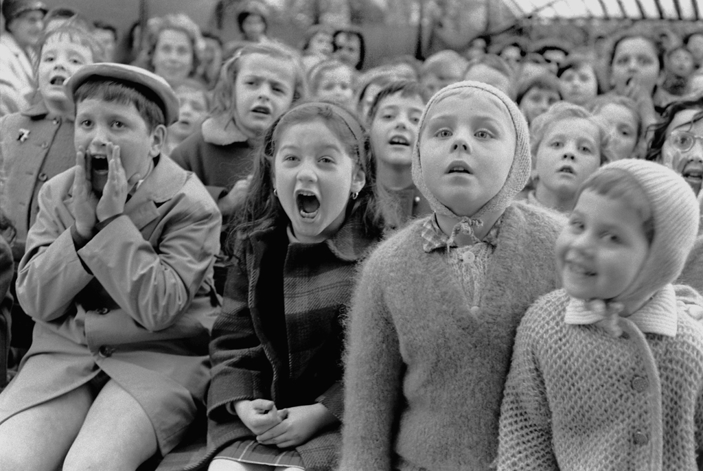 Children watch the story of "Saint George and the Dragon" at an outdoor puppet theater in Paris, 1963.