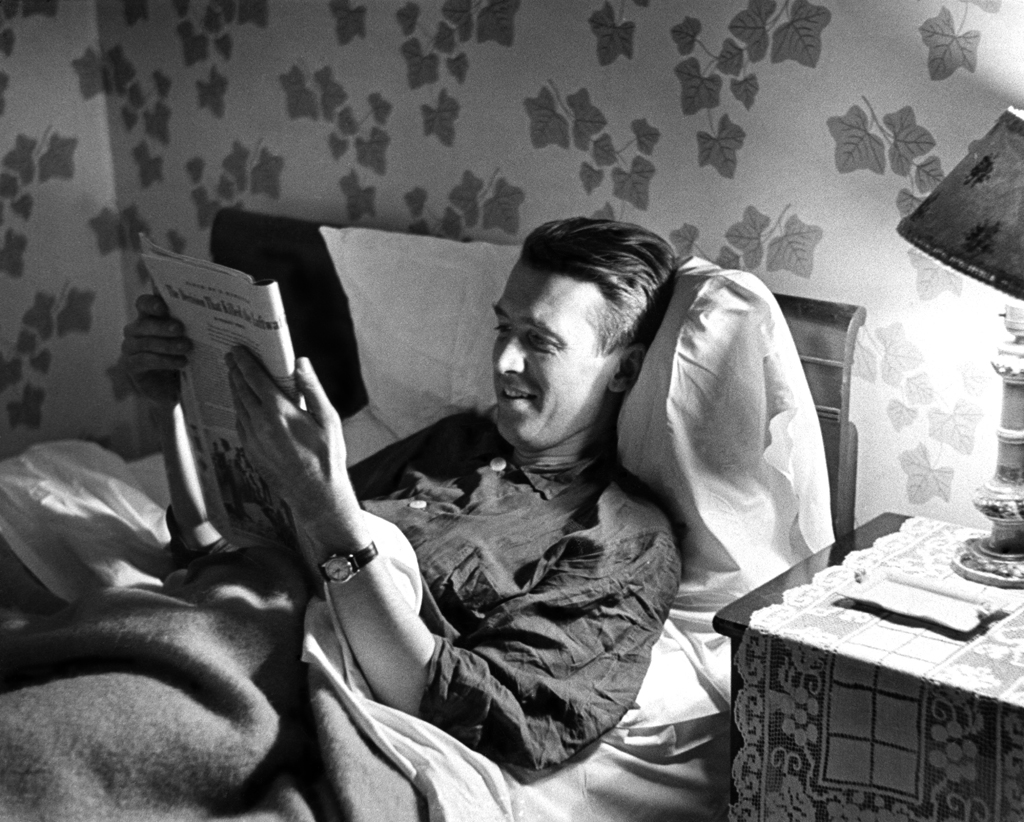 James Stewart, back home after serving in World War II, reads in bed at his parents' house, Indiana, Pa., 1945.