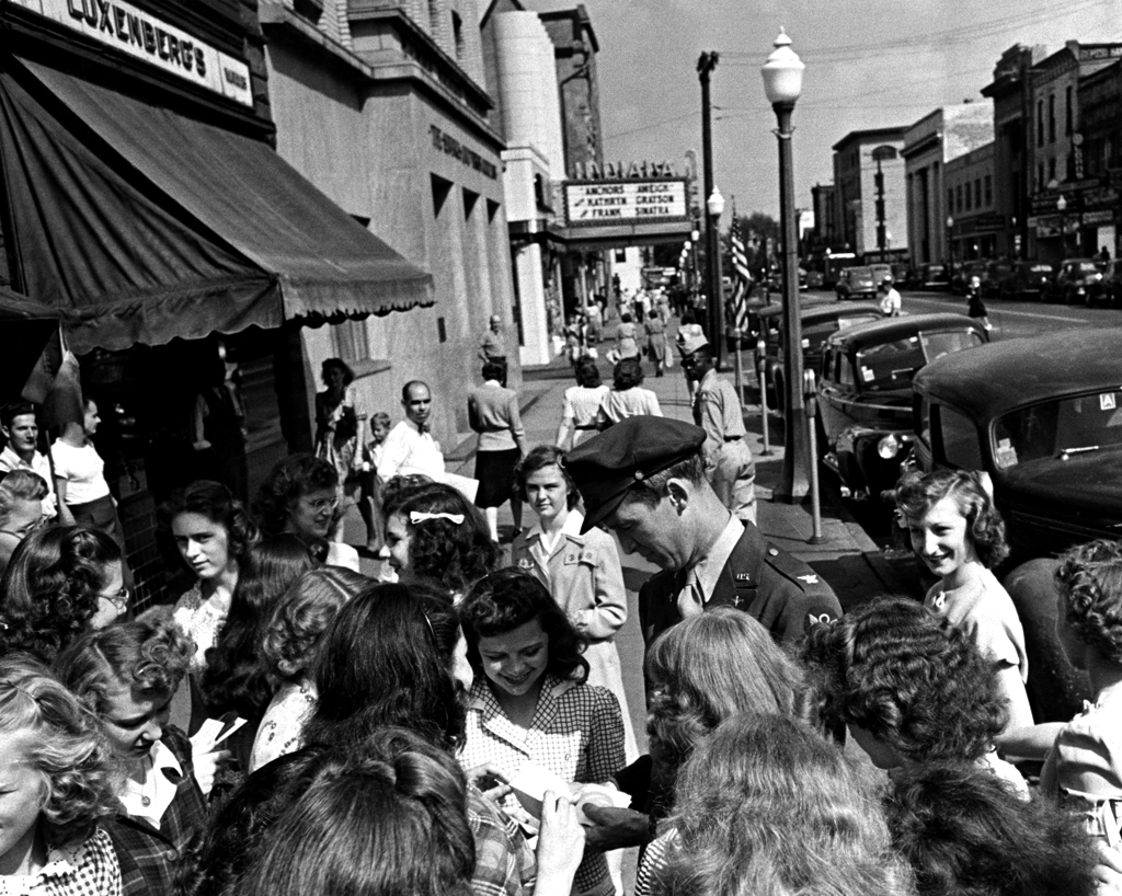 The movie star and war vet Jimmy Stewart signs autographs for local girls, Indiana, Pa., 1945.