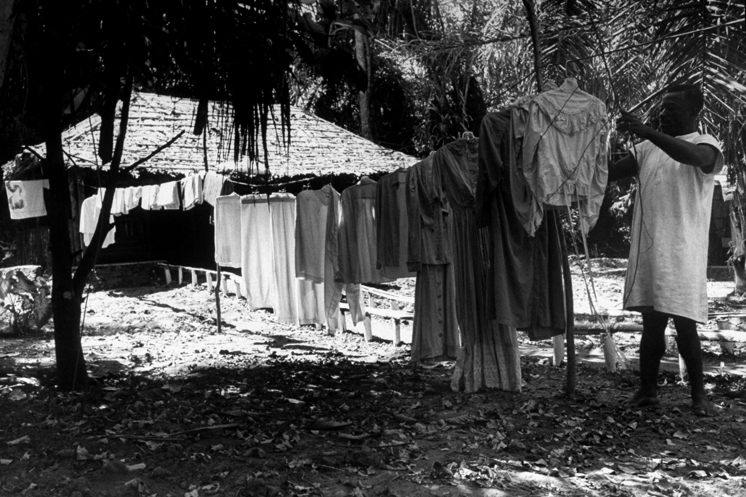 A local resident tends to the wardrobe for Katharine Hepburn on location for The African Queen.