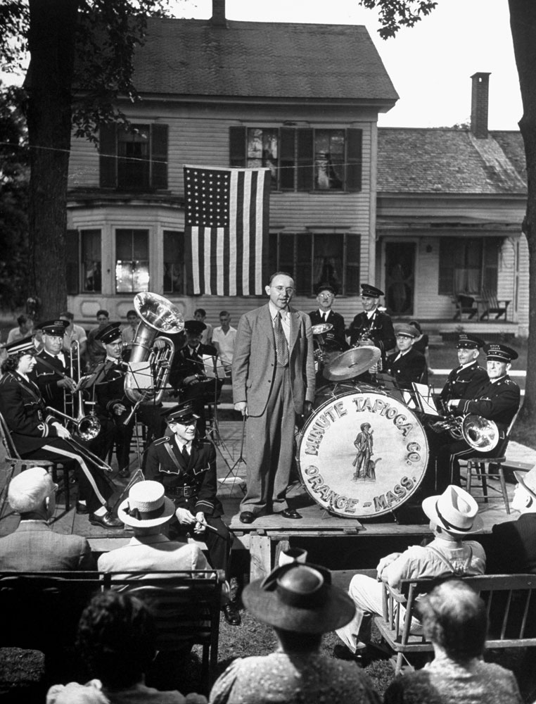 Republican candidate for Congress Raymond Leslie Buell gives a campaign speech on a platform surrounded by townspeople in a small Massachusetts park in August 1942.