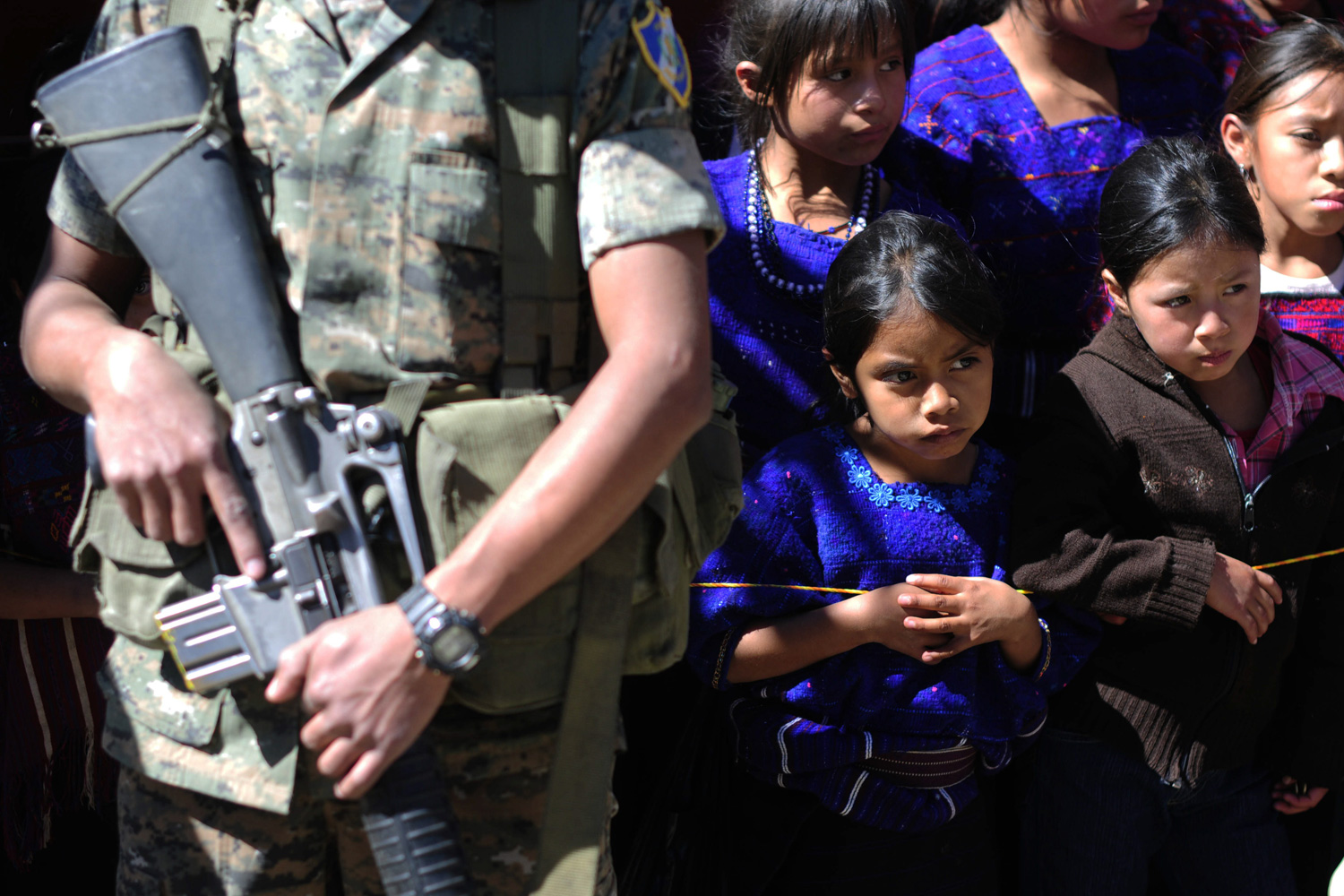 Feb. 16, 2012. A soldier guards Guatemalan president Otto Perez Molina during his visit to San Juan Atitan, Guatemala.