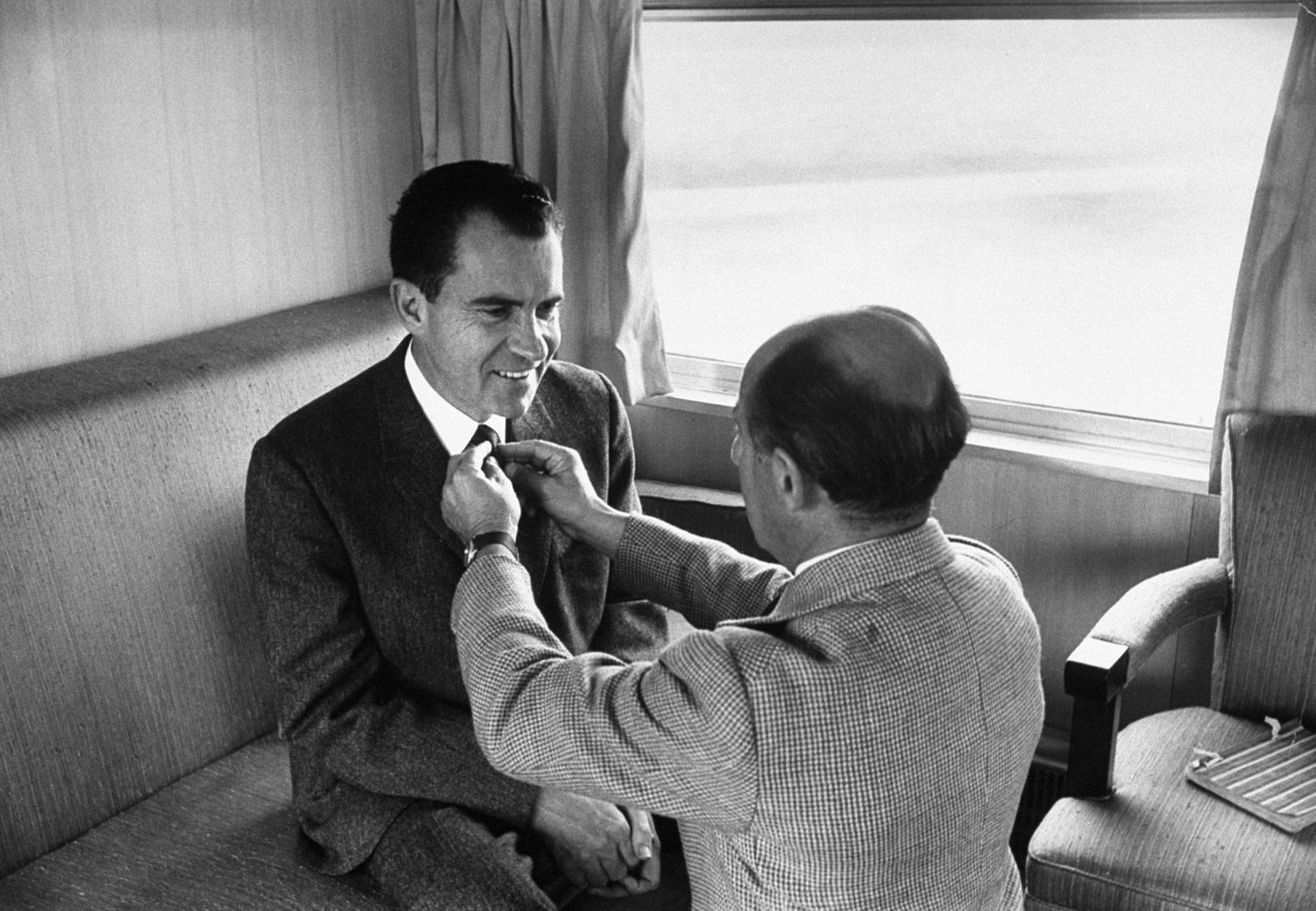 LIFE photographer Alfred Eisenstaedt adjusts Richard Nixon's tie prior to photo shoot during the 1960 presidential campaign.