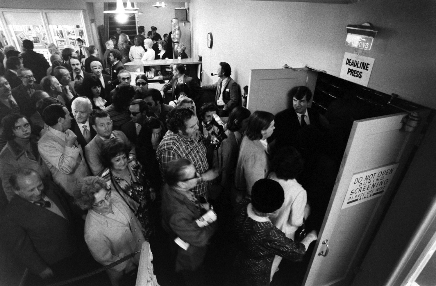 Members of the Academy enter an auditorium for a screening of an Oscar nominated film, 1972.