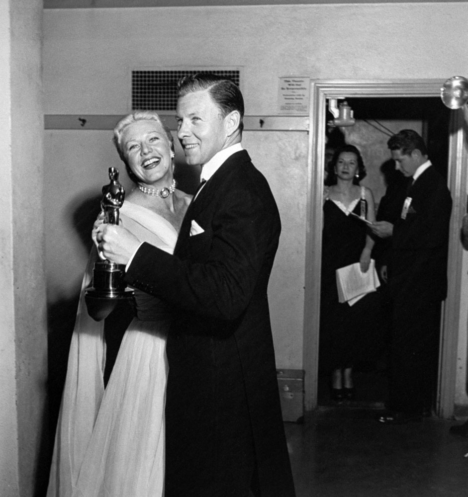 Presenters Ginger Rogers and George Murphy dance together while holding an Oscar backstage at the RKO Pantages Theatre in 1950.