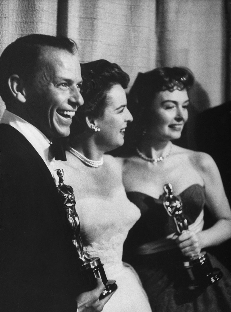 Frank Sinatra and Donna Reed hold their Oscars as Best Supporting Actor and Actress in From Here to Eternity — a film that won eight statuettes in 1954, including Best Picture.