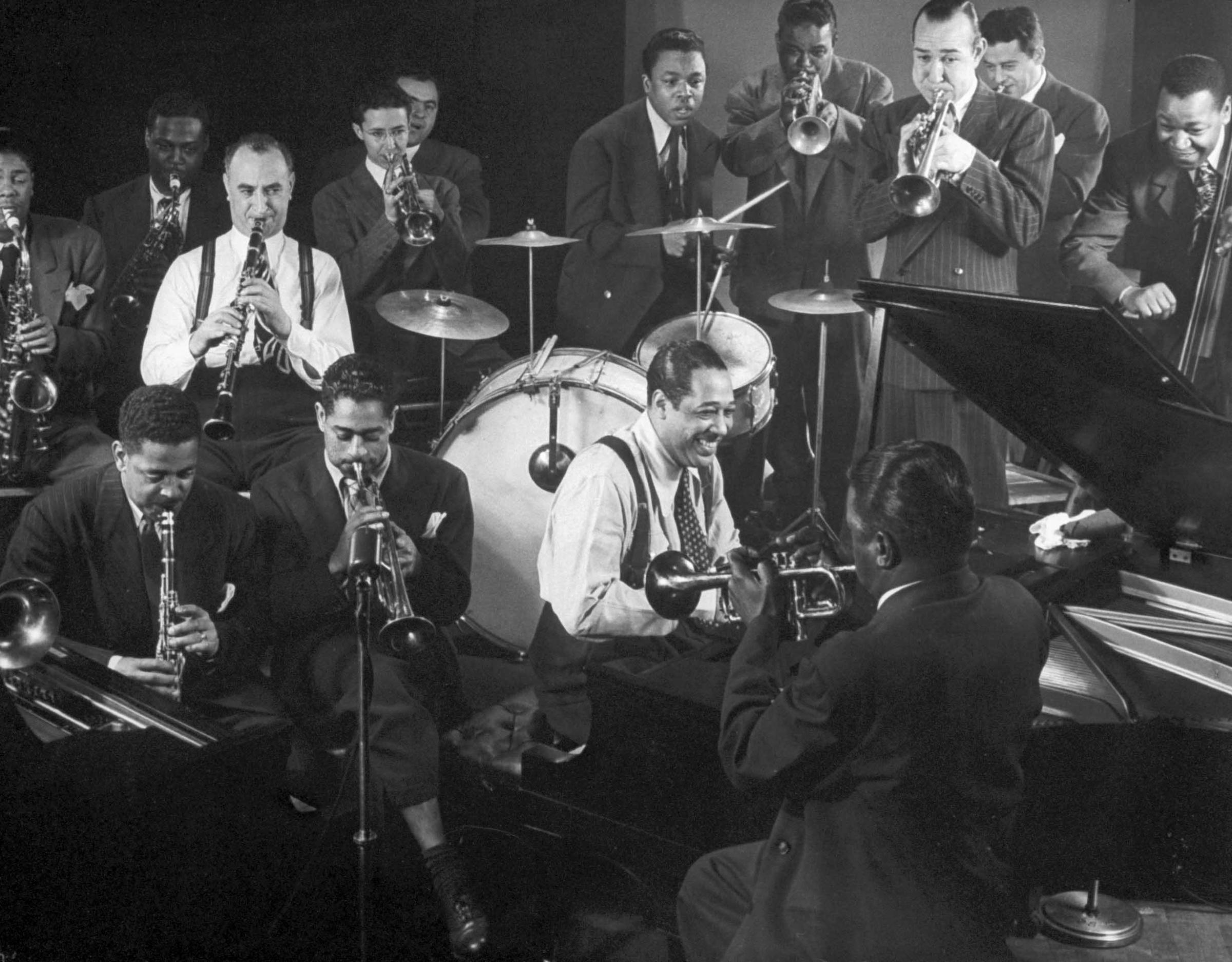 Duke Ellington at the piano as Dizzy Gillespie (seated behind Ellington) and others swing, 1943.