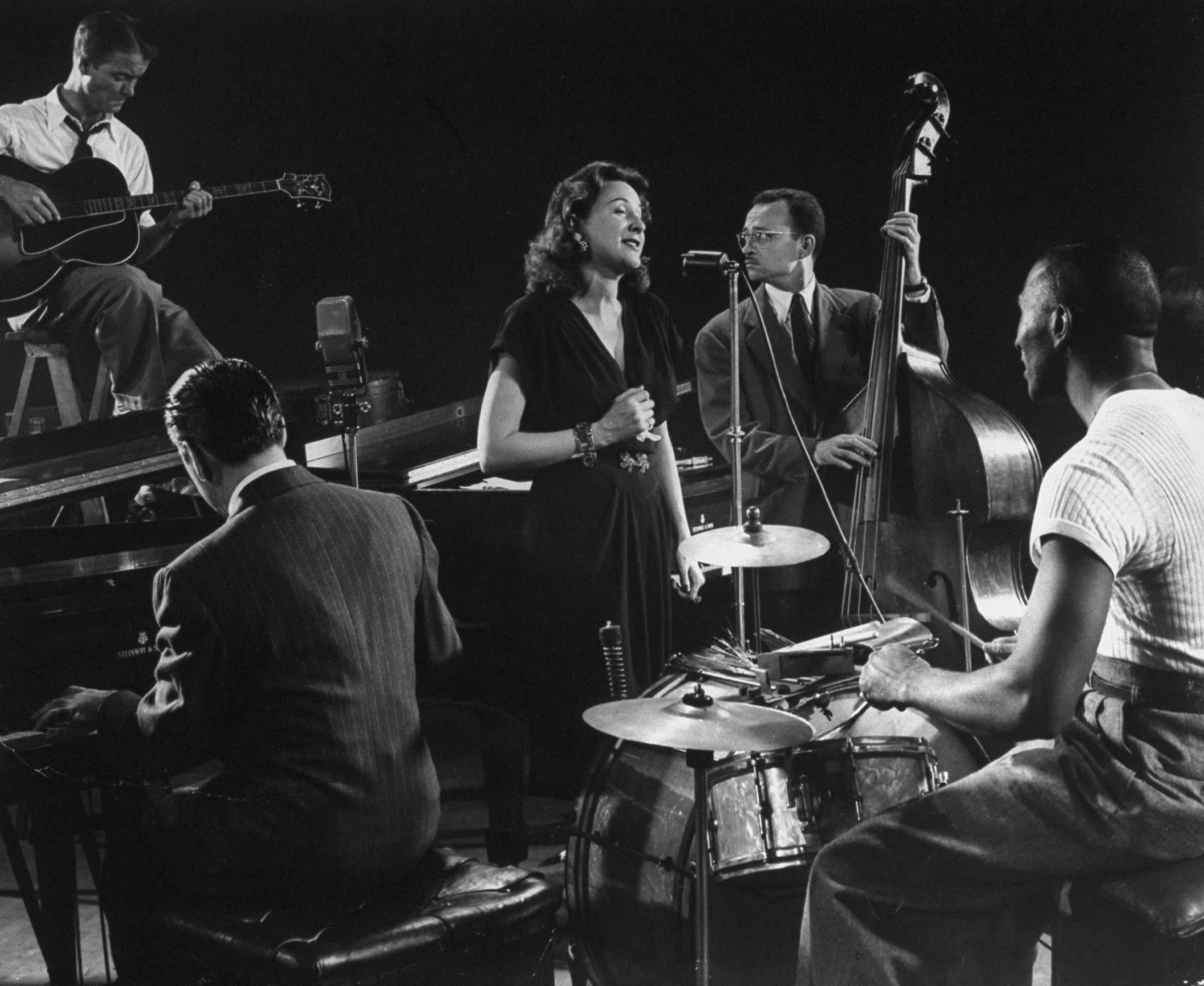 Vocalist Lee Wiley sings, accompanied by her husband, pianist Jess Stacy, with Eddie Condon on guitar, Sid Weiss on bass and the great Cozy Cole on drums, 1943.