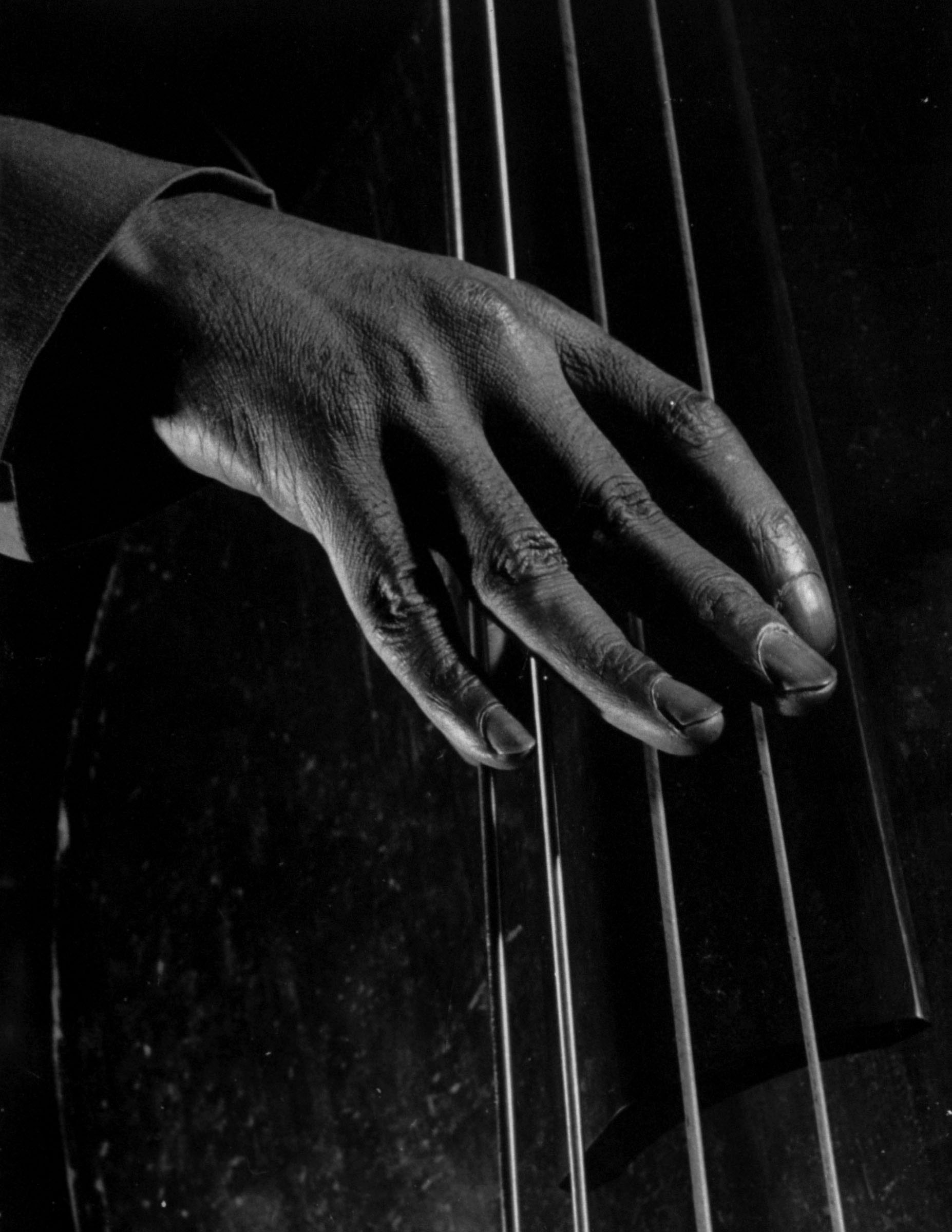 An unidentified bass player's fingers, 1943.